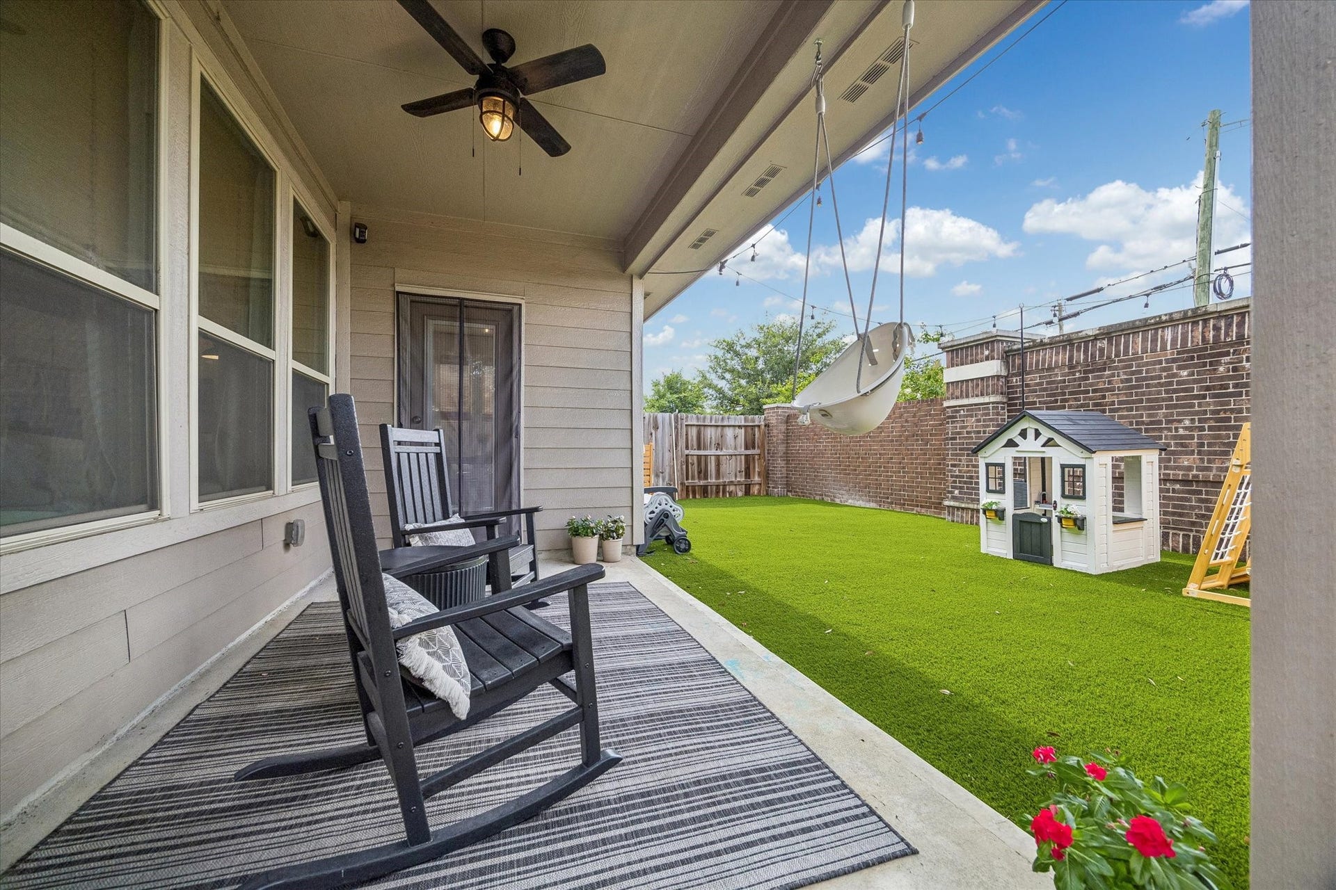 Enjoy morning coffee or evening relaxation under the shaded patio overlooking the backyard.