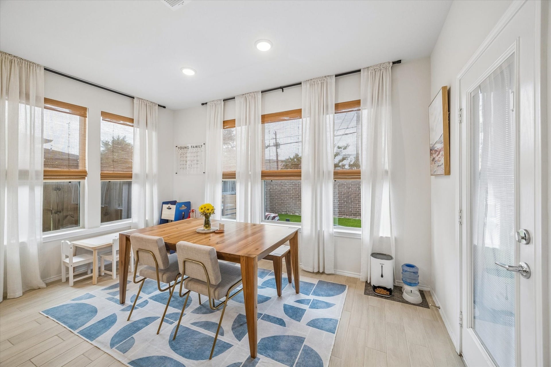 Surrounded by windows, this inviting dining space is ideal for both everyday meals and special occasions.