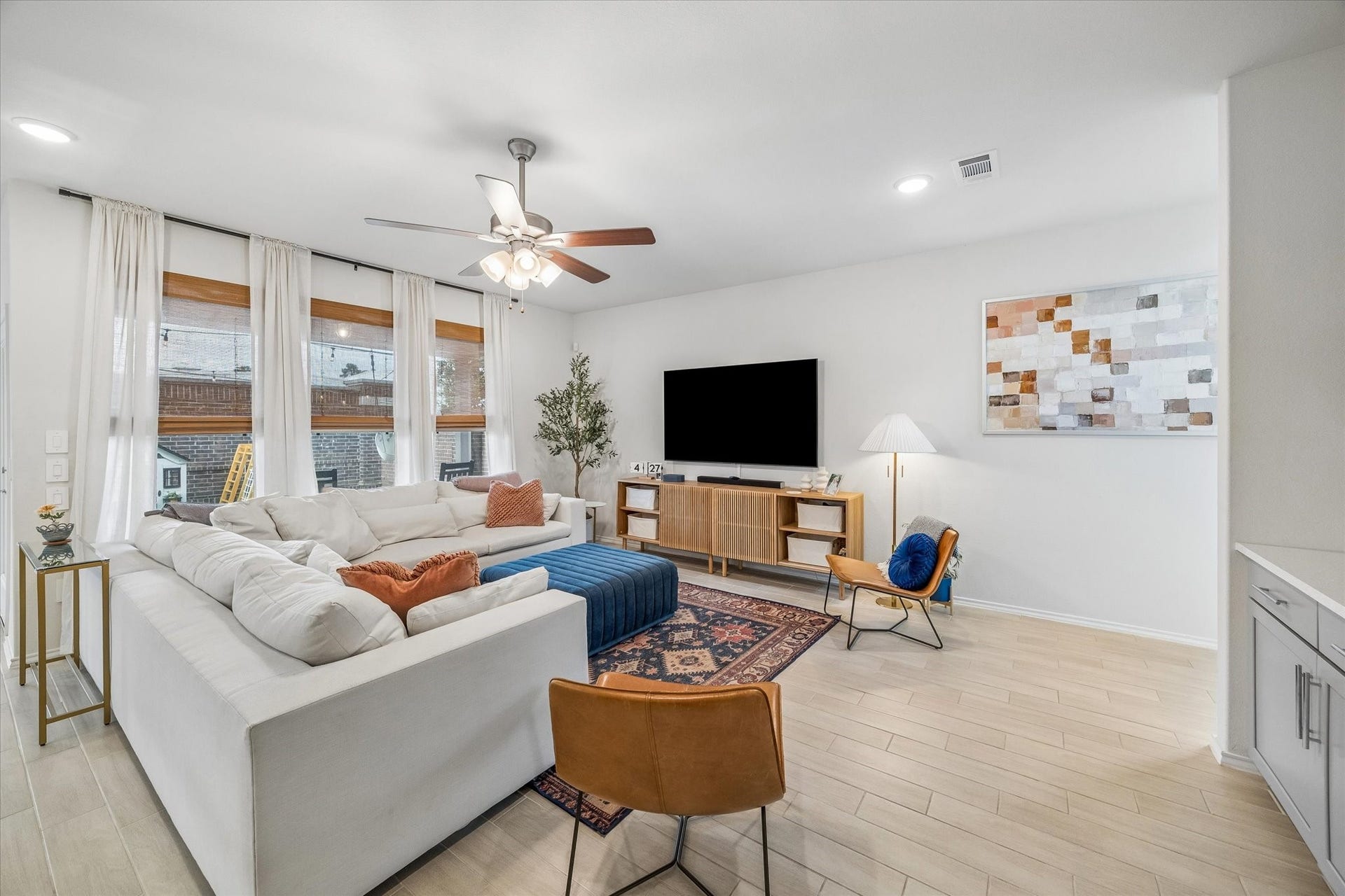 Spacious family room seamlessly connects to the kitchen and dining area, ideal for entertaining.
