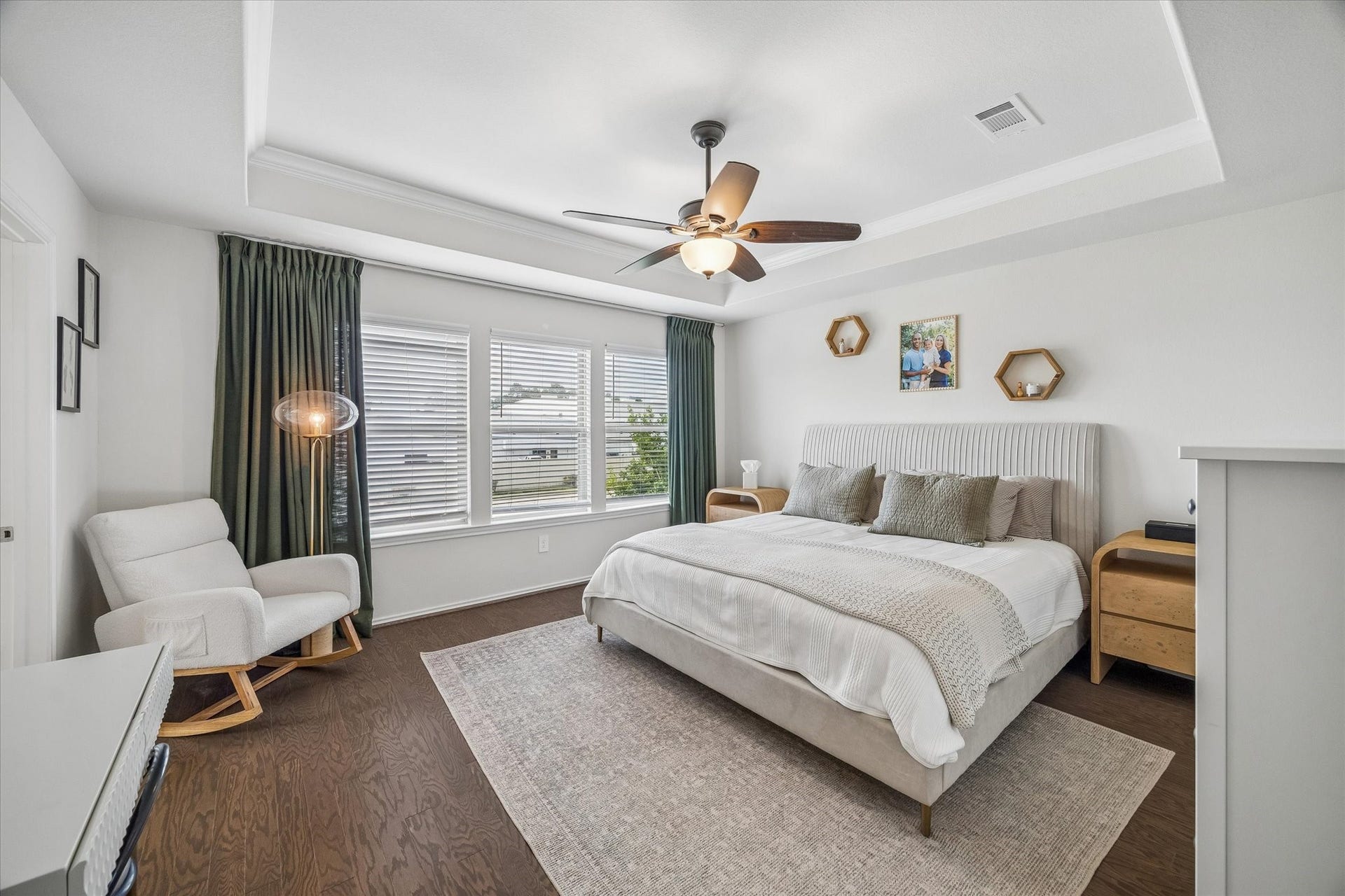 Spacious owner's suite featuring a tray ceiling, abundant natural light, and room to unwind.