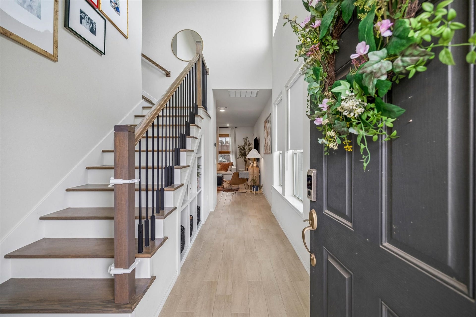 Beautiful flooring, natural light, and a striking staircase create a welcoming arrival experience.