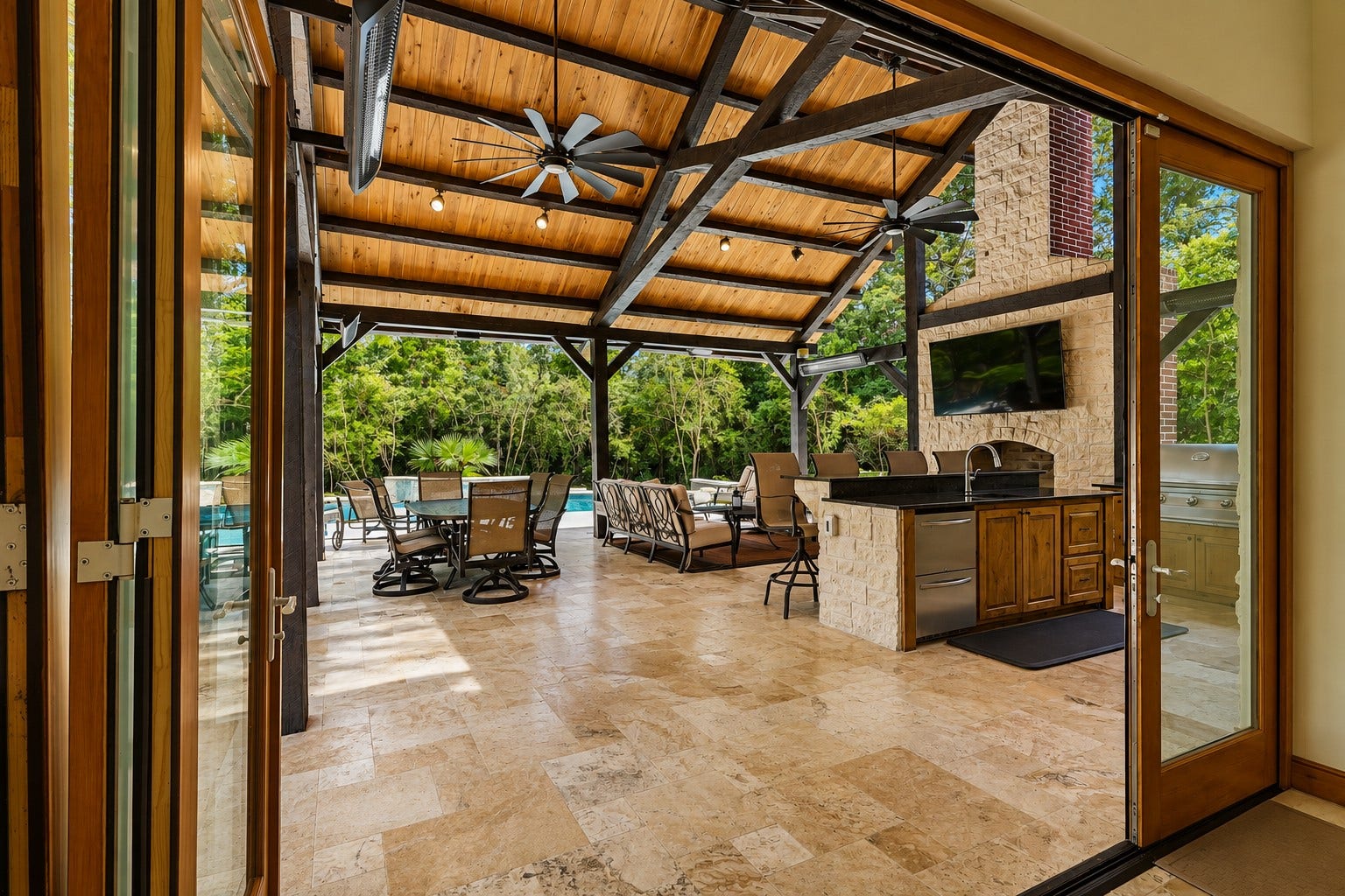 7 Pastoral Pond Circle, The Woodlands, TX 77380 The massive pavilion is located directly off the guest house and features bifold doors that open completely for seamless indoor-outdoor entertaining
