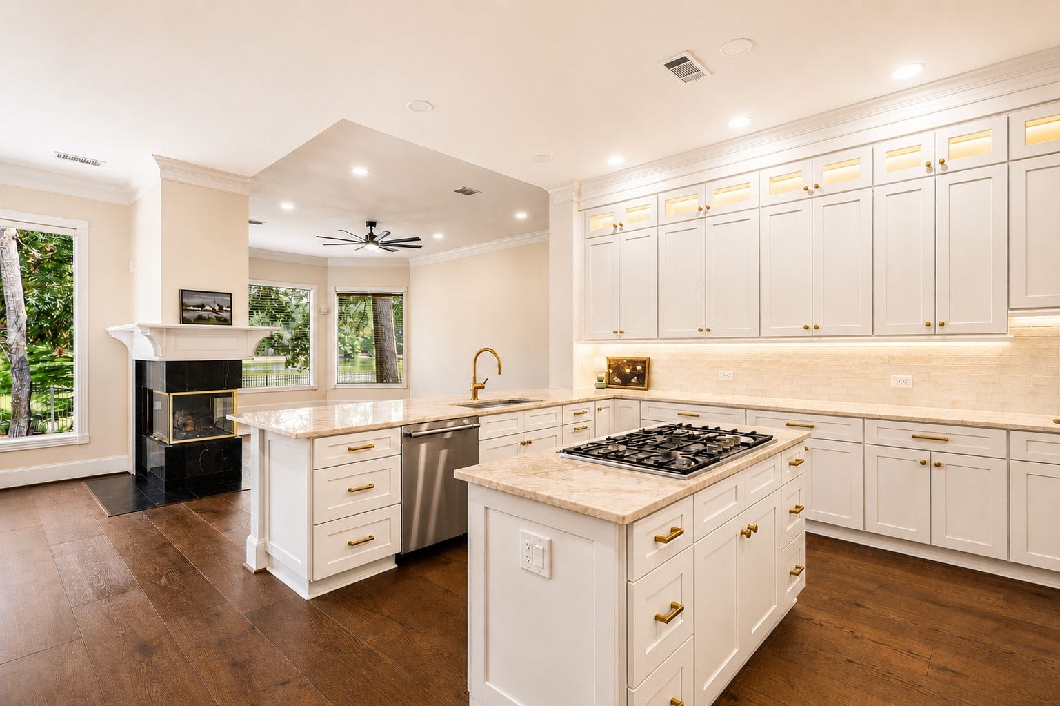 7 Pastoral Pond Circle, The Woodlands, TX 77380 Bright, modern kitchen featuring brand-new stainless steel appliances, a professional-grade gas cooktop, and elegant Taj Mahal quartzite countertops.