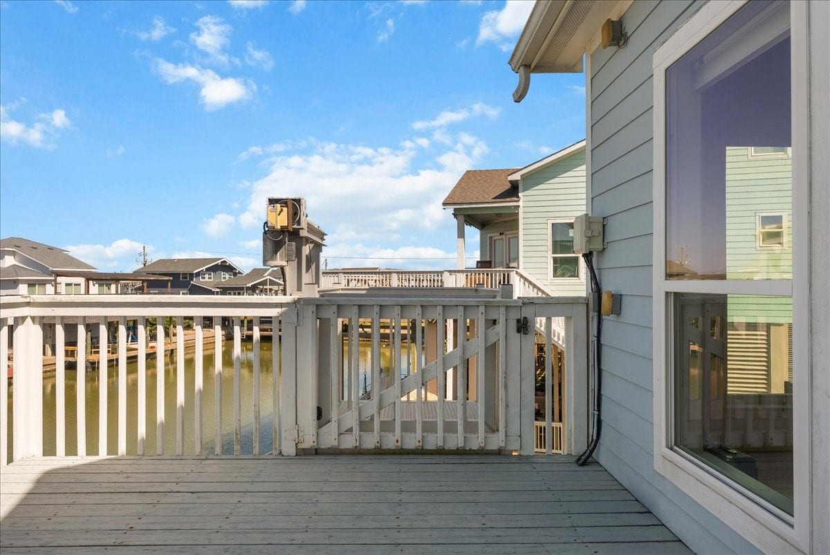 314 Windward Way, Tiki Island, TX 77554 Enjoy an expansive deck, private boathouse, covered parking beneath the home, additional garage space, and exceptional outdoor livingall just a short walk from the neighborhood park.