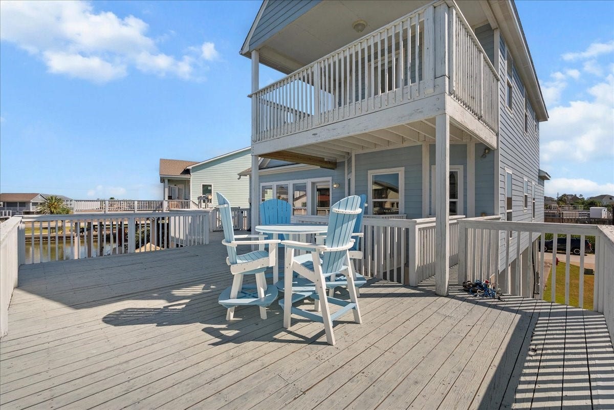 314 Windward Way, Tiki Island, TX 77554 Enjoy an expansive deck, private boathouse, covered parking beneath the home, additional garage space, and exceptional outdoor livingall just a short walk from the neighborhood park.