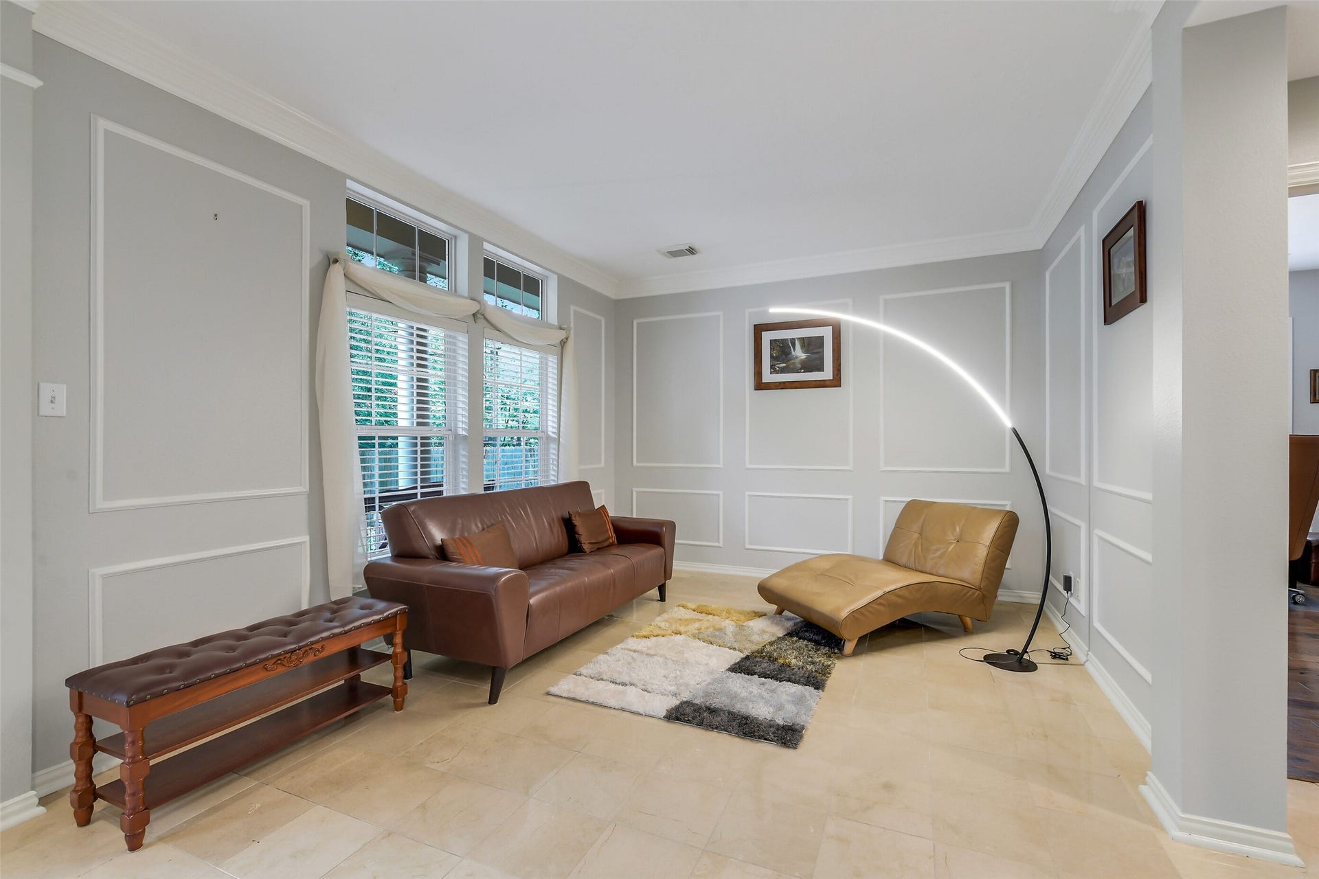 7 Larkspur Trail, The Woodlands, TX 77382 Elegant living room featuring a modern, complemented by large windows with abundant natural light.