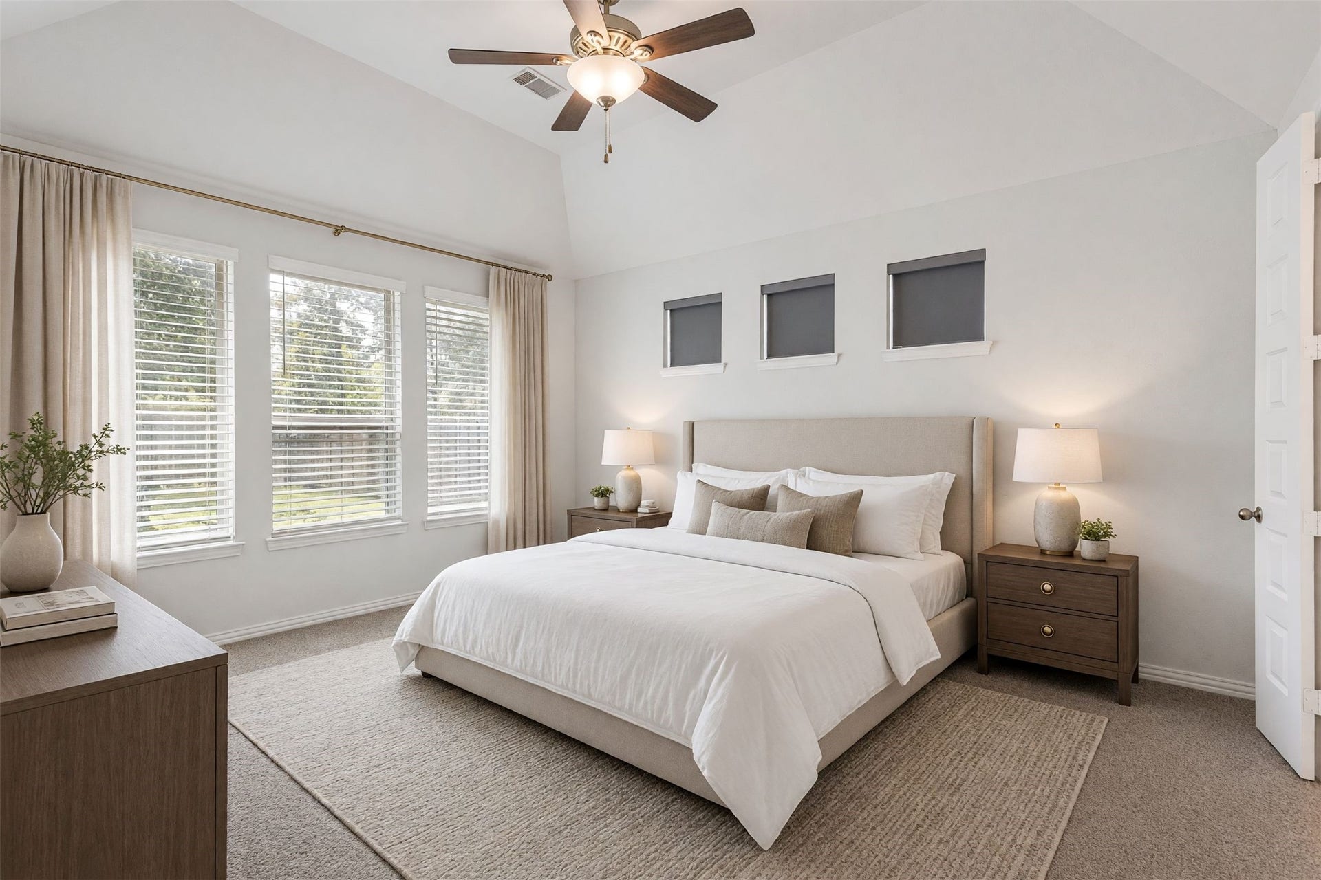 Virtually staged primary suite. The spacious primary bedroom features windows that welcome natural light, creating a bright and relaxing retreat.