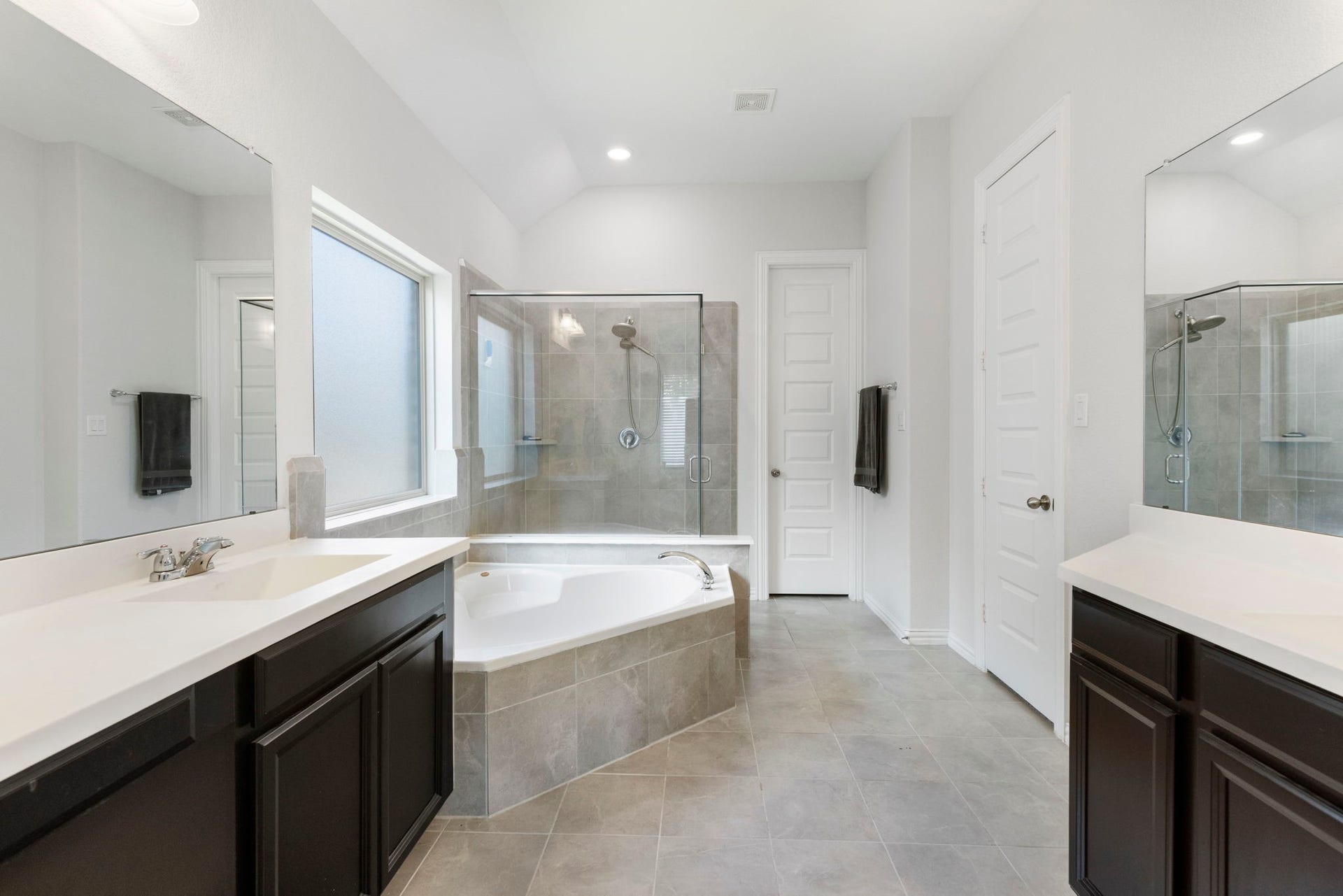 Well-appointed primary bathroom offers a comfortable and functional space for everyday convenience.