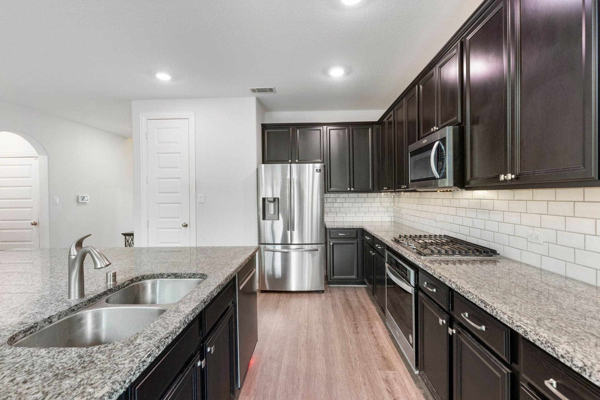 The kitchen offers ample cabinet storage and countertop space for everyday meal preparation and entertaining.