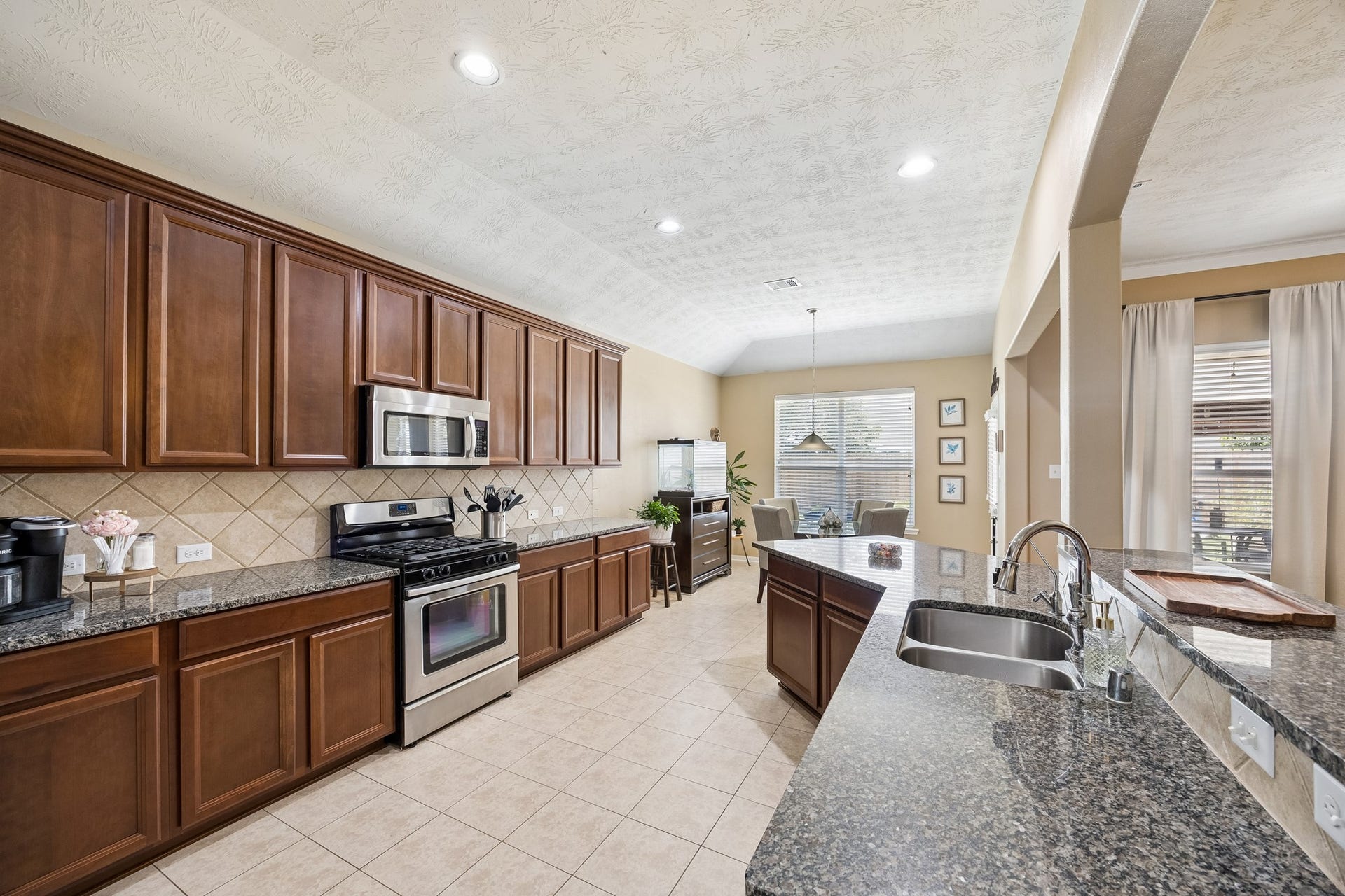 26251 Caper Meadow Lane, Katy, TX 77494 Plenty of cabinets and storage in the Kitchen. There are rich granite countertops, beautiful wood cabinets, stainless steel appliance and recessed lighting.