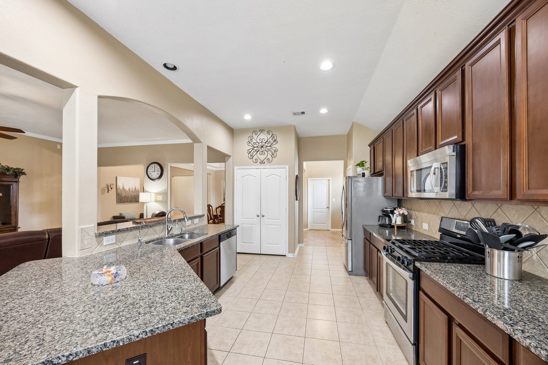 26251 Caper Meadow Lane, Katy, TX 77494 The Kitchen has two great sized pantries for storage and the door at the end of the room leads to the large laundry room that opens out to the oversized three car garage.
