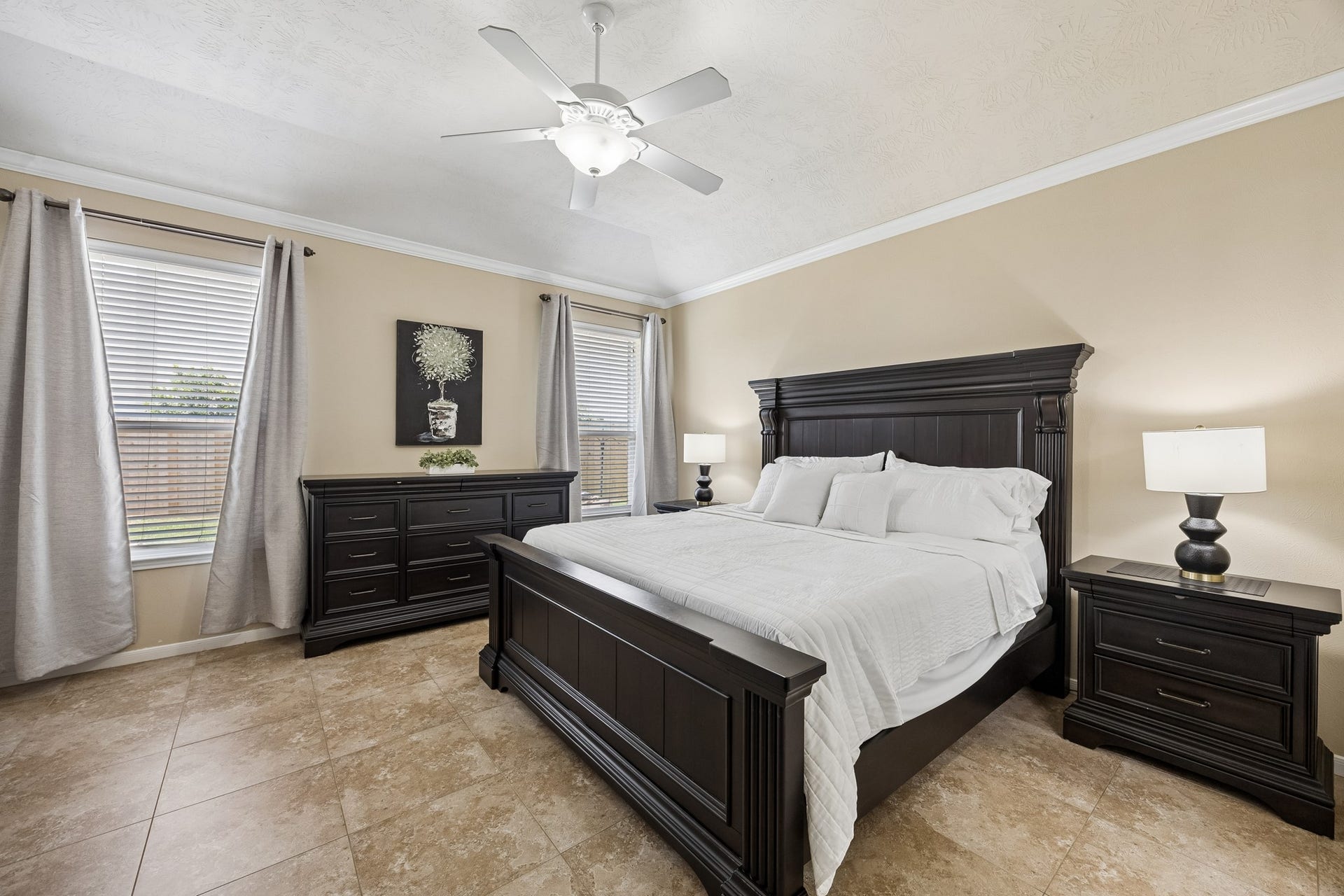 26251 Caper Meadow Lane, Katy, TX 77494 The Primary Suite is on the 1st floor and features light/fan, double windows, crown molding, and tile. Room overlooks the backyard.