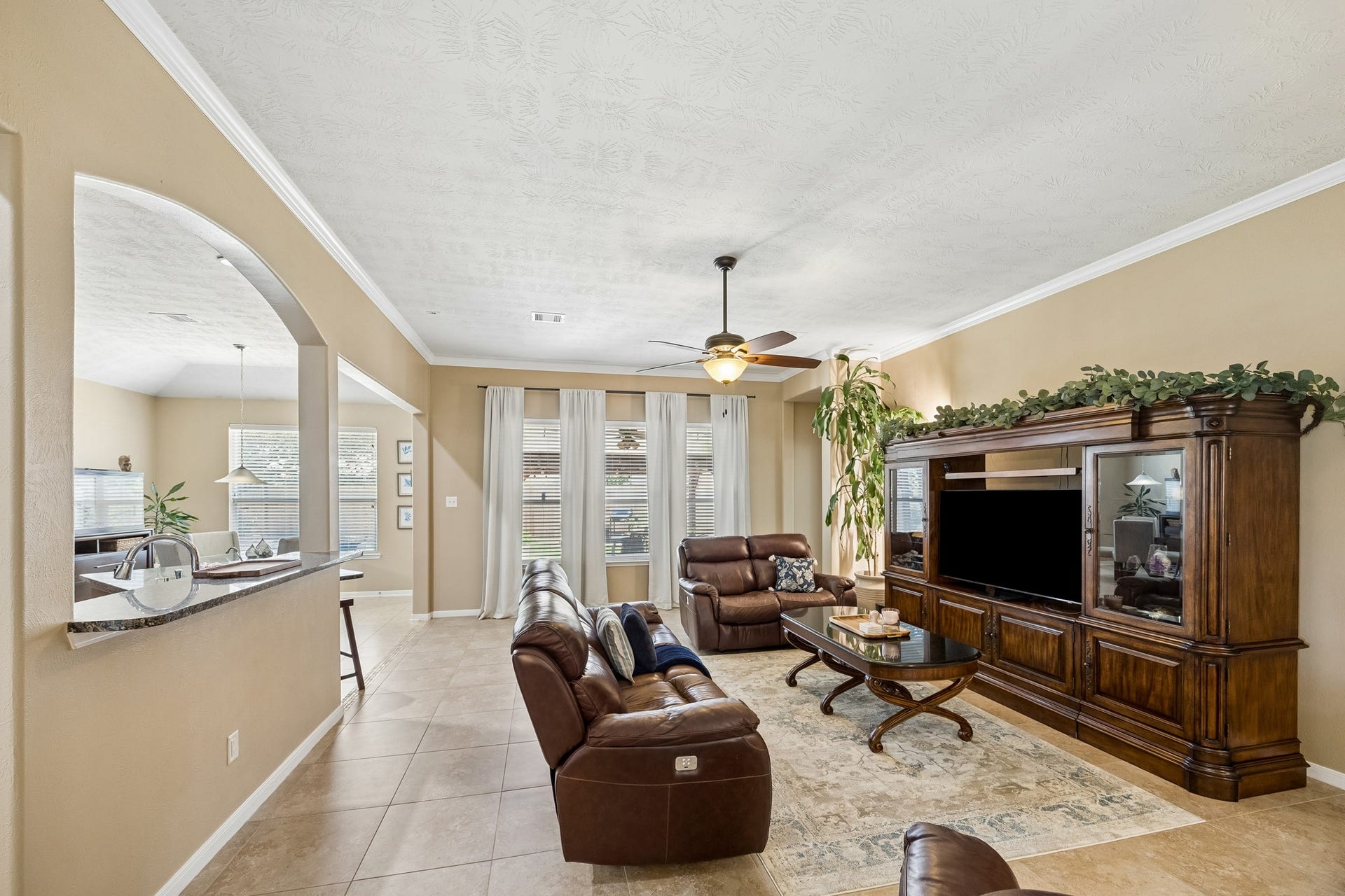 26251 Caper Meadow Lane, Katy, TX 77494 Plenty of room for even the largest furniture in this Family Room. The window from Kitchen features a granite high bar and room for bar stools.