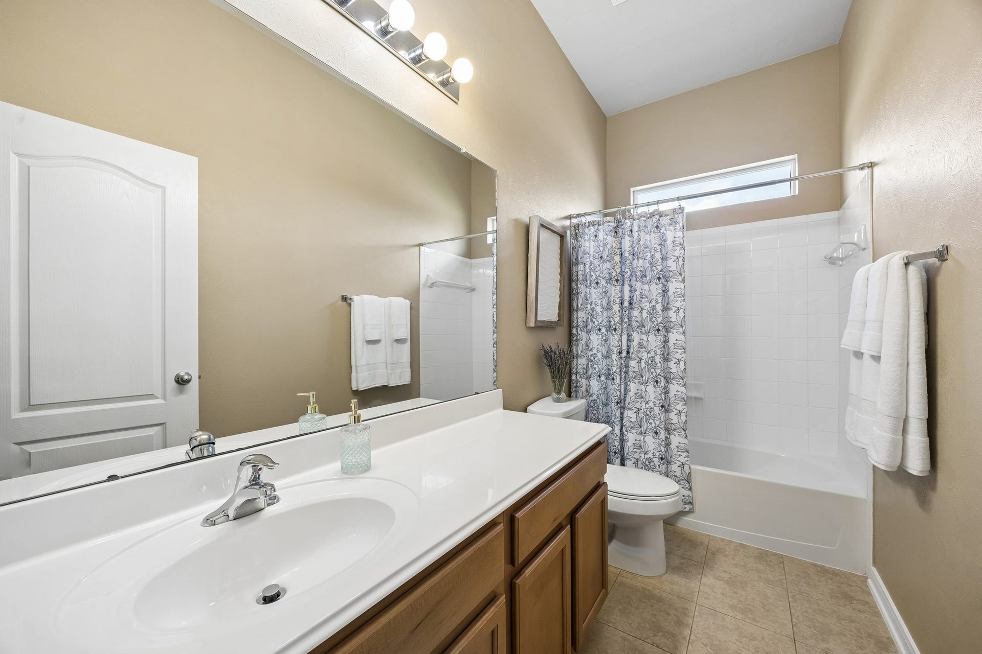 26251 Caper Meadow Lane, Katy, TX 77494 Between the two bedrooms is a full bathroom with rich wood cabinets, tub/shower with window over to let in natural light.