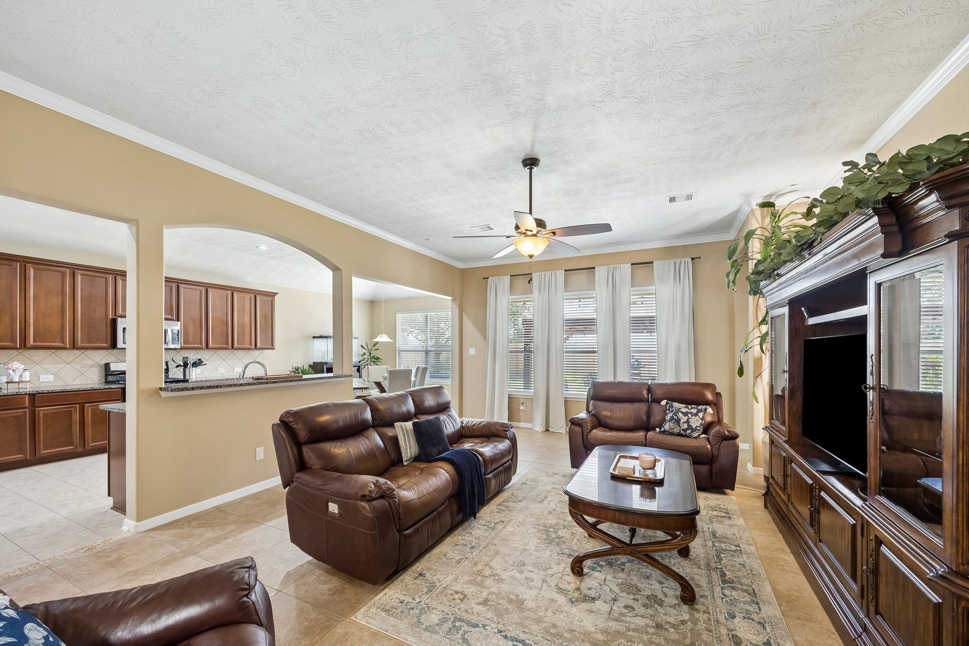 26251 Caper Meadow Lane, Katy, TX 77494 The Family room has a triple set of windows and completely open to the Kitchen. This room also features the crown molding, neutral paint, and tile floors for easy care.