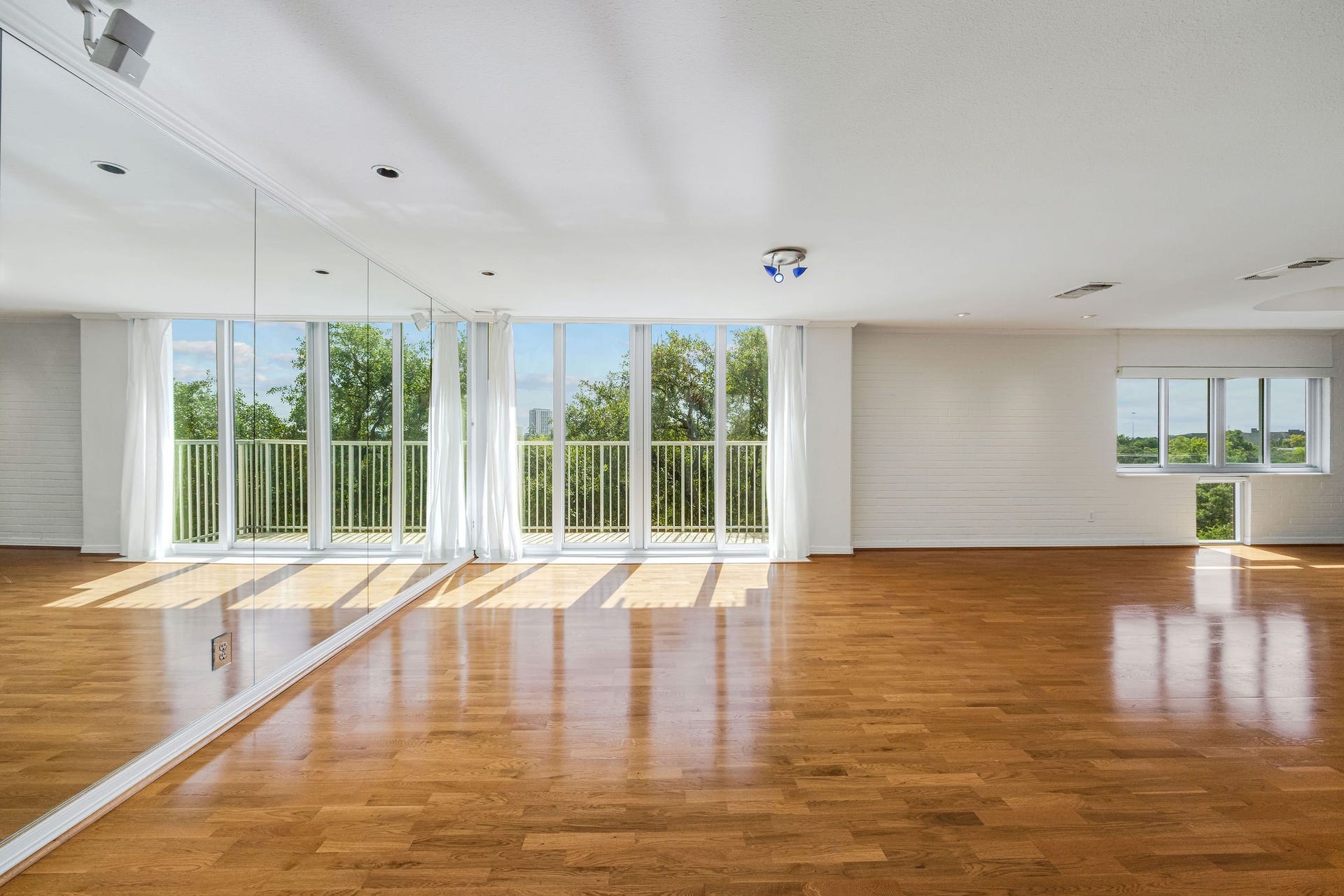 3600 Montrose Boulevard, #501, Houston, TX 77006 Spacious room with abundant natural light, featuring floor-to-ceiling windows and elegant hardwood floors.