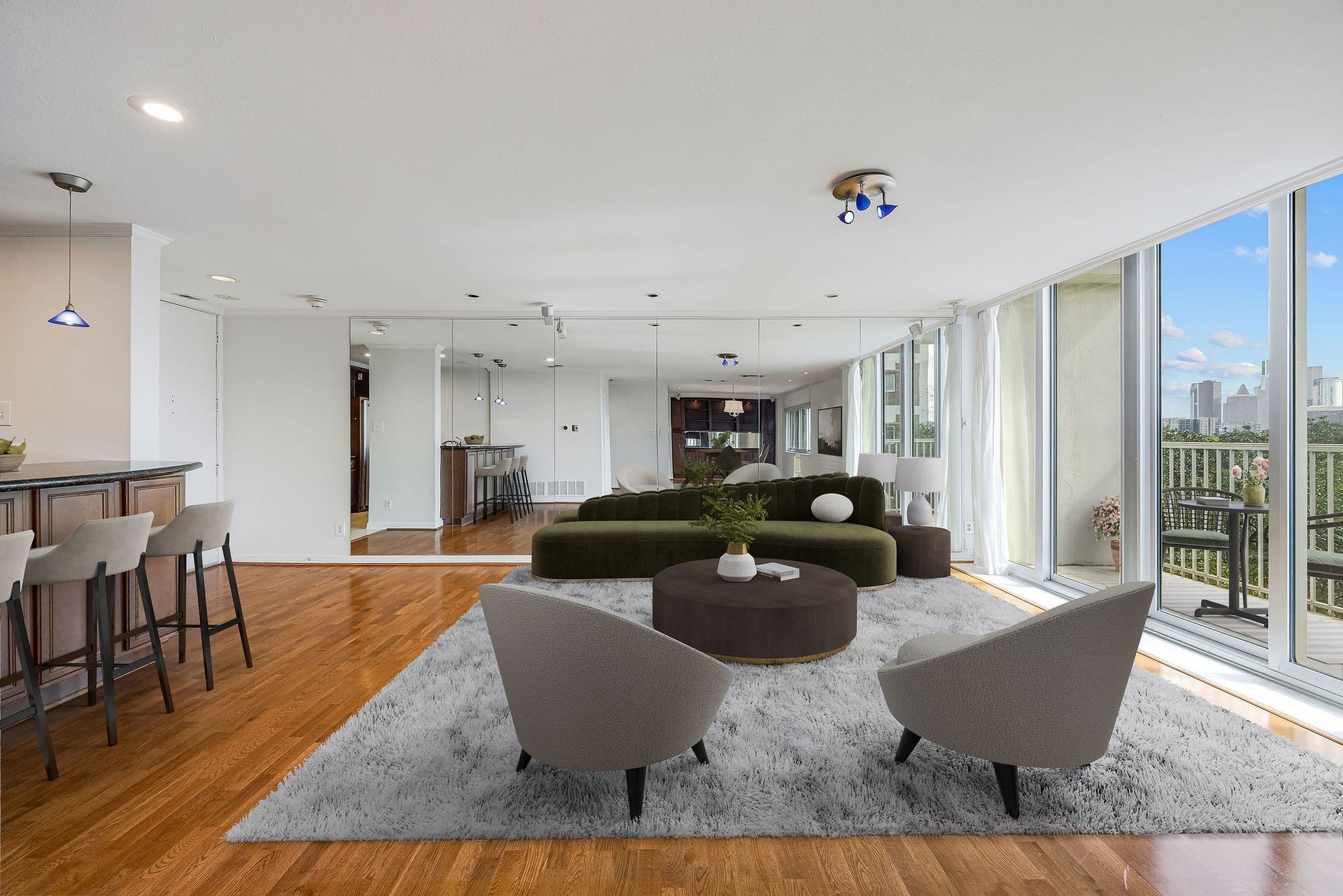 3600 Montrose Boulevard, #501, Houston, TX 77006 The virtual staged photo shows a spacious and modern living area featuring floor-to-ceiling windows with city views, sleek hardwood flooring, and a stylish open-concept design perfect for entertaining.