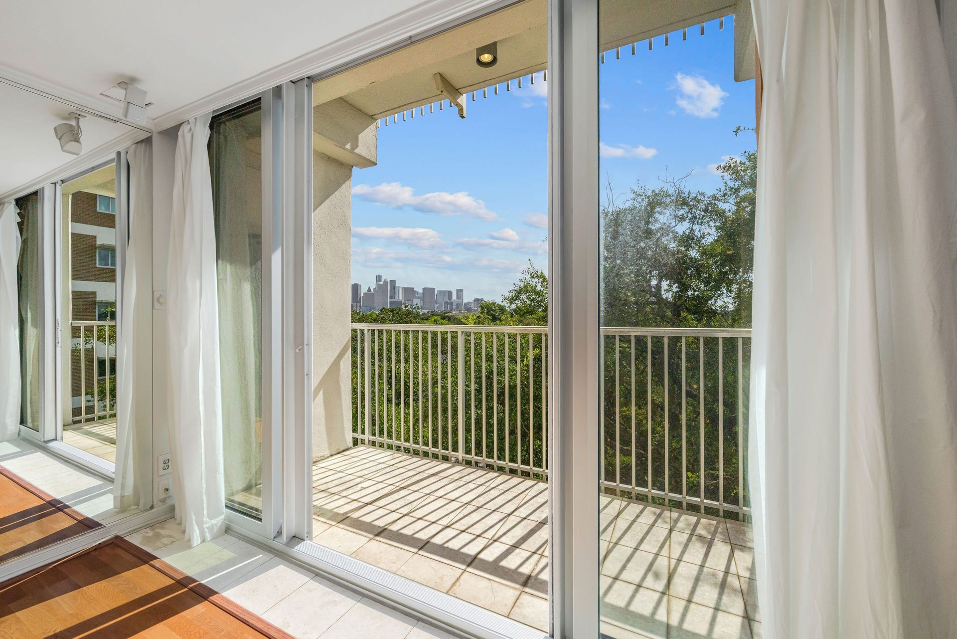 3600 Montrose Boulevard, #501, Houston, TX 77006 Expansive floor-to-ceiling windows open to a private balcony with stunning city skyline views, offering an abundance of natural light.