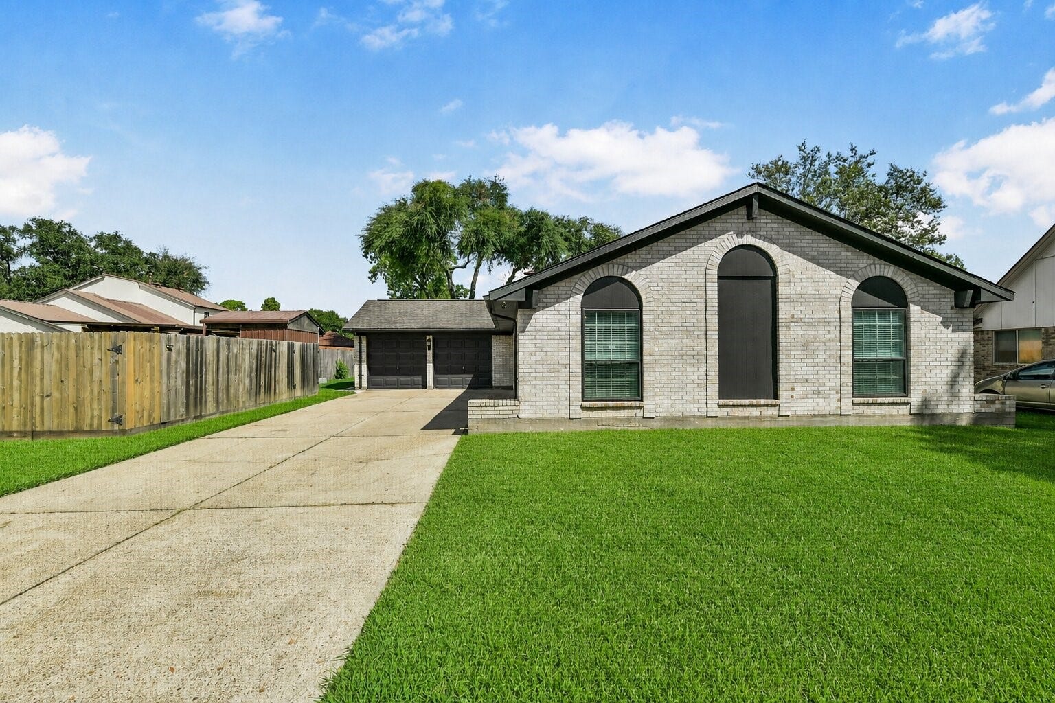 5003 Colombia Drive, Pasadena, TX 77505 Charming single-story home with a spacious driveway, classic brick exterior, and well-maintained lawn, offering ample space and great curb appeal.