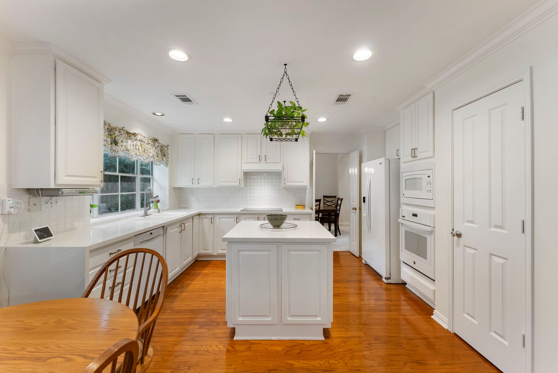 74 E Greywing Circle, The Woodlands, TX 77382 The kitchen was redone in 2025 to add quartz cascade countertops and the induction cooktop. The cabinets were freshly painted also.