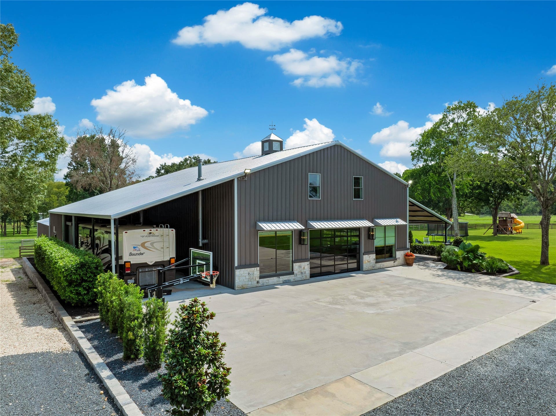 Oversized RV carport with 50-amp electrical service, septic dump, and generous covered parking for your motorhome, trailer or equipment. Rock driveway to left, full access to take trailer and farm equipment to back pastures.