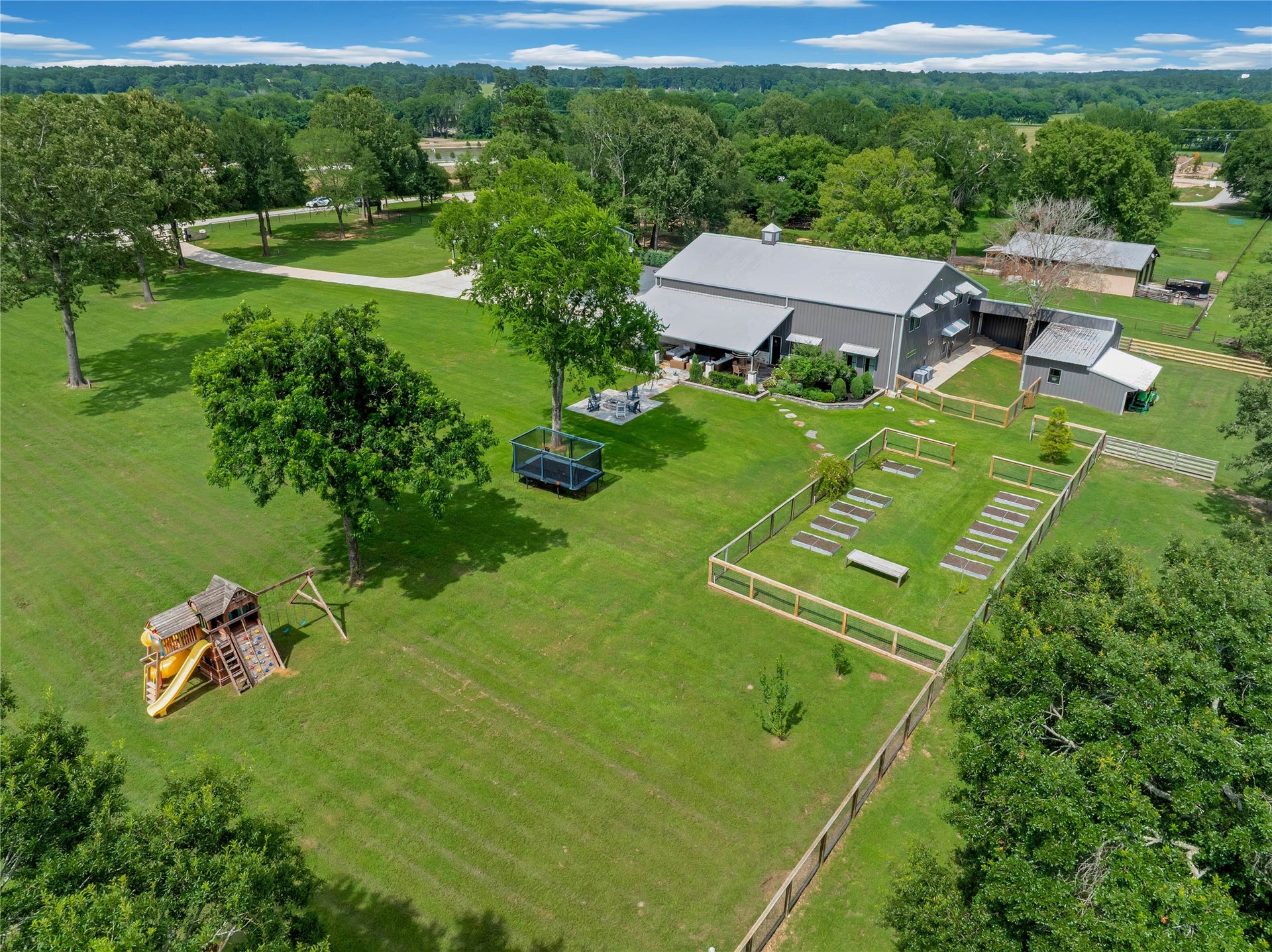 Thoughtfully designed acreage with irrigated 12 raised garden beds & in-ground garden space, four-rail fencing with dog-proofing, cross-fenced pastures, loafing shed/barn and mature hardwoods.