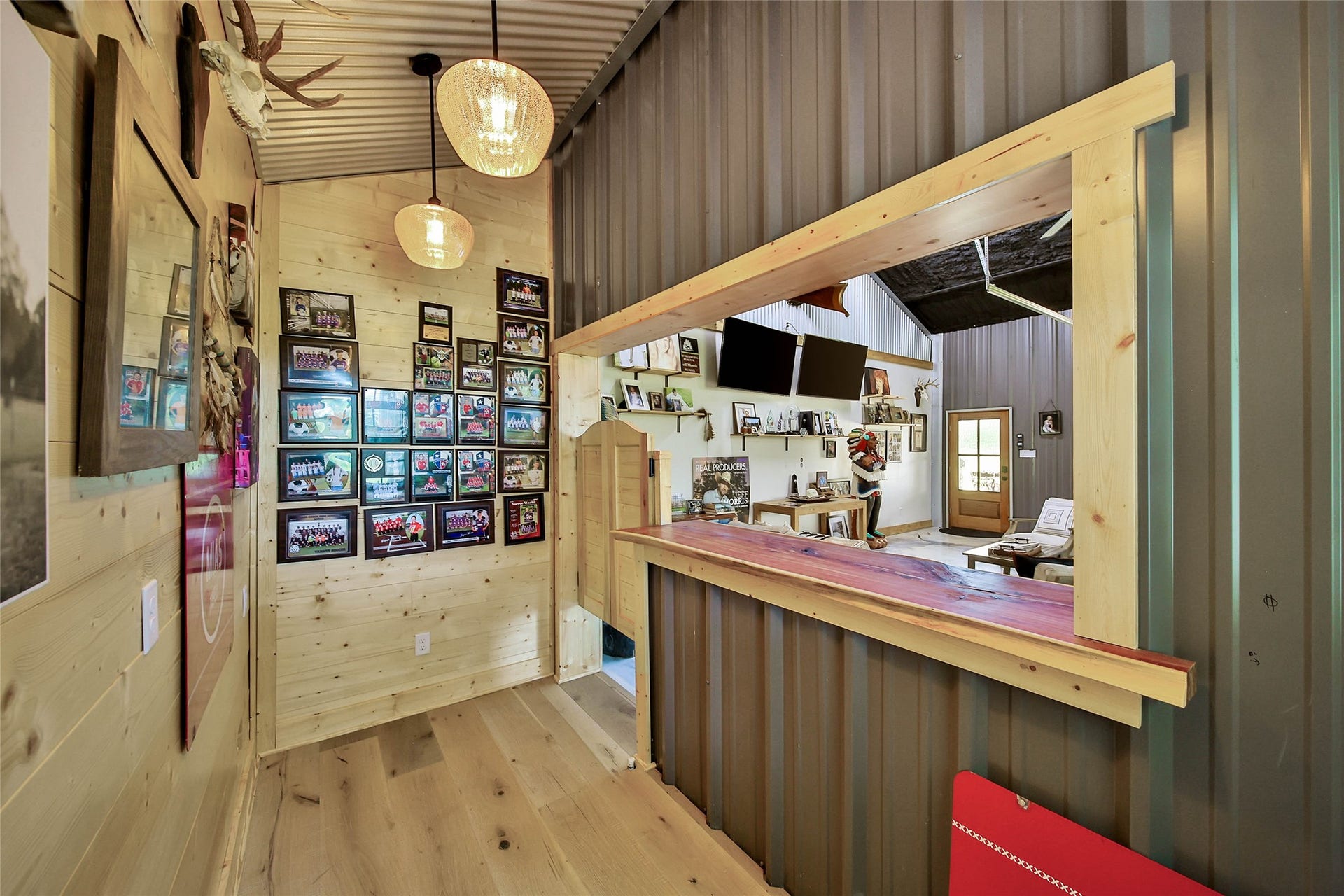 Rustic serving area showcases knotty pine walls and custom live-edge serving ledge.
