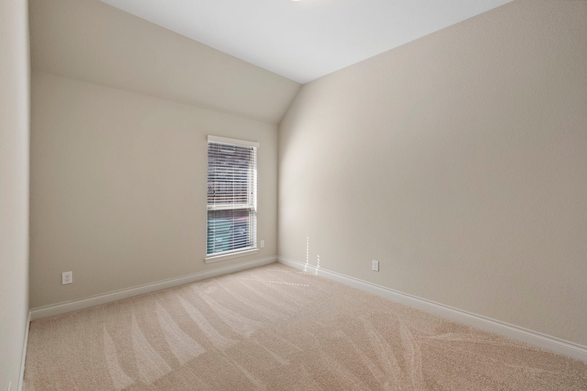 2030 Rainy Mist Drive, Missouri City, TX 77459 Spacious third bedroom offers plush carpet, neutral finishes, and a large window.