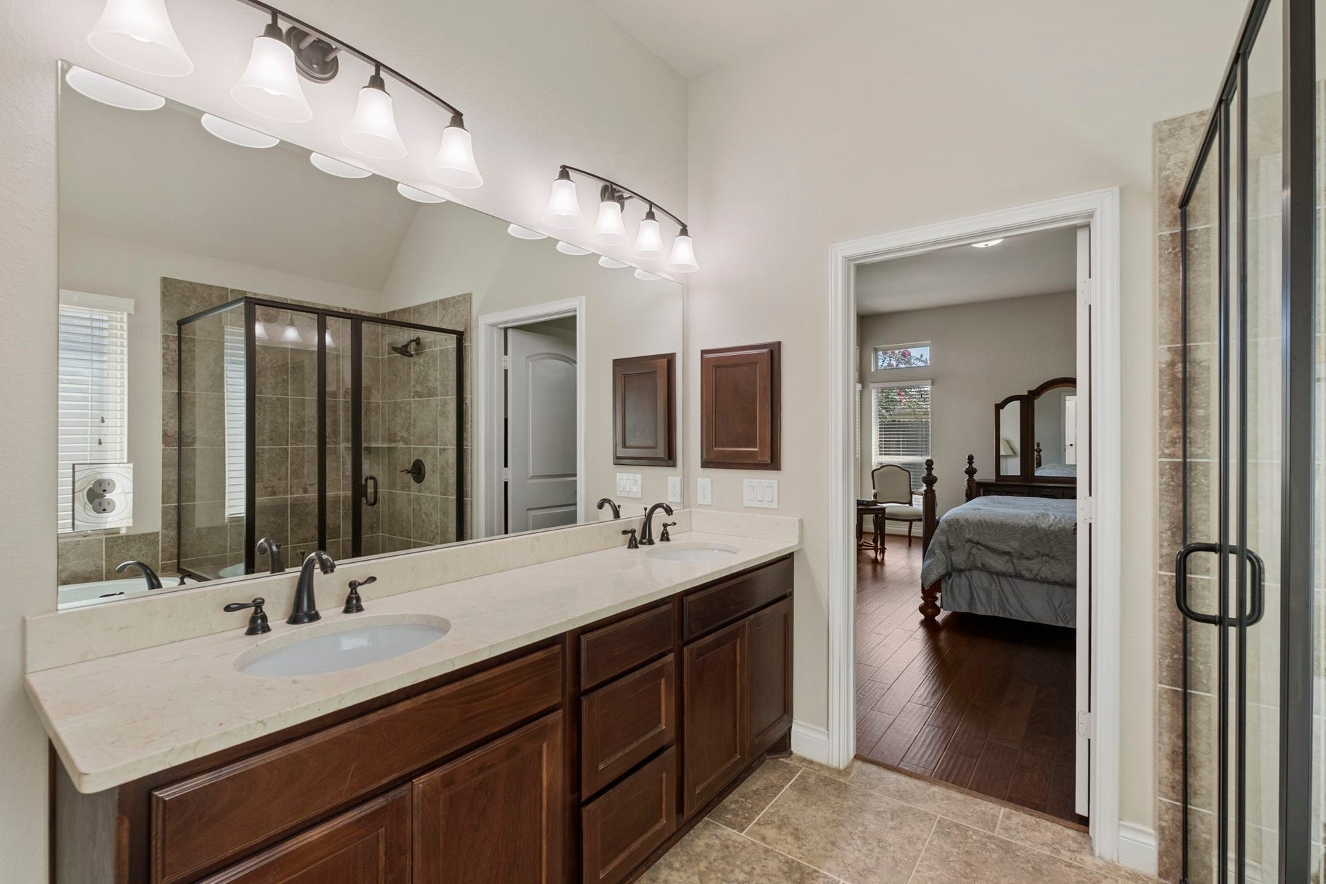 2030 Rainy Mist Drive, Missouri City, TX 77459 Spa-inspired primary bath is complete with an oversized soaking tub and separate glass-enclosed shower, with Windermere bronze hardware throughout.