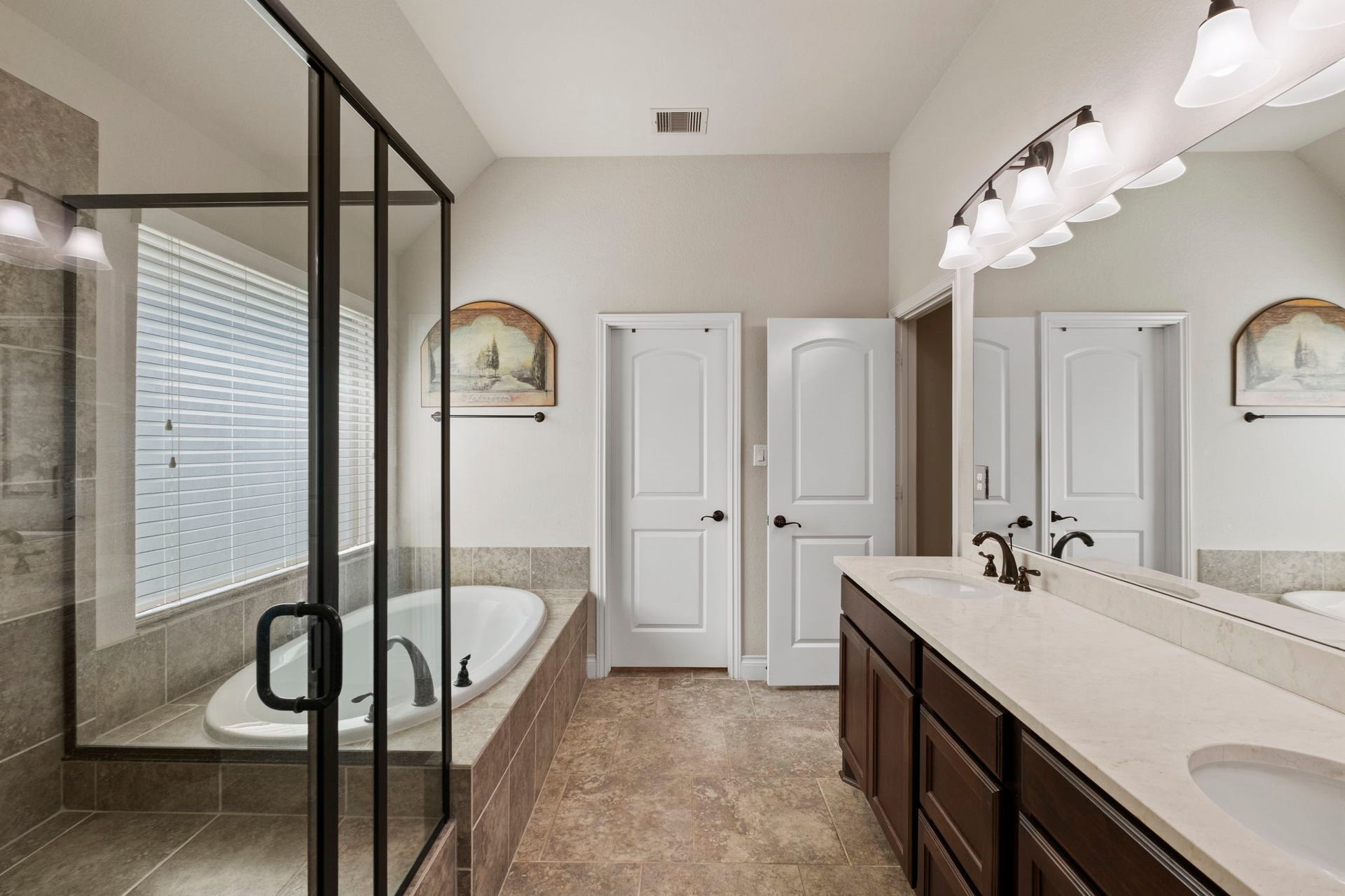 2030 Rainy Mist Drive, Missouri City, TX 77459 Large primary bath features dual vanities with, generous counter space made of Crema Marble, and abundant storage.