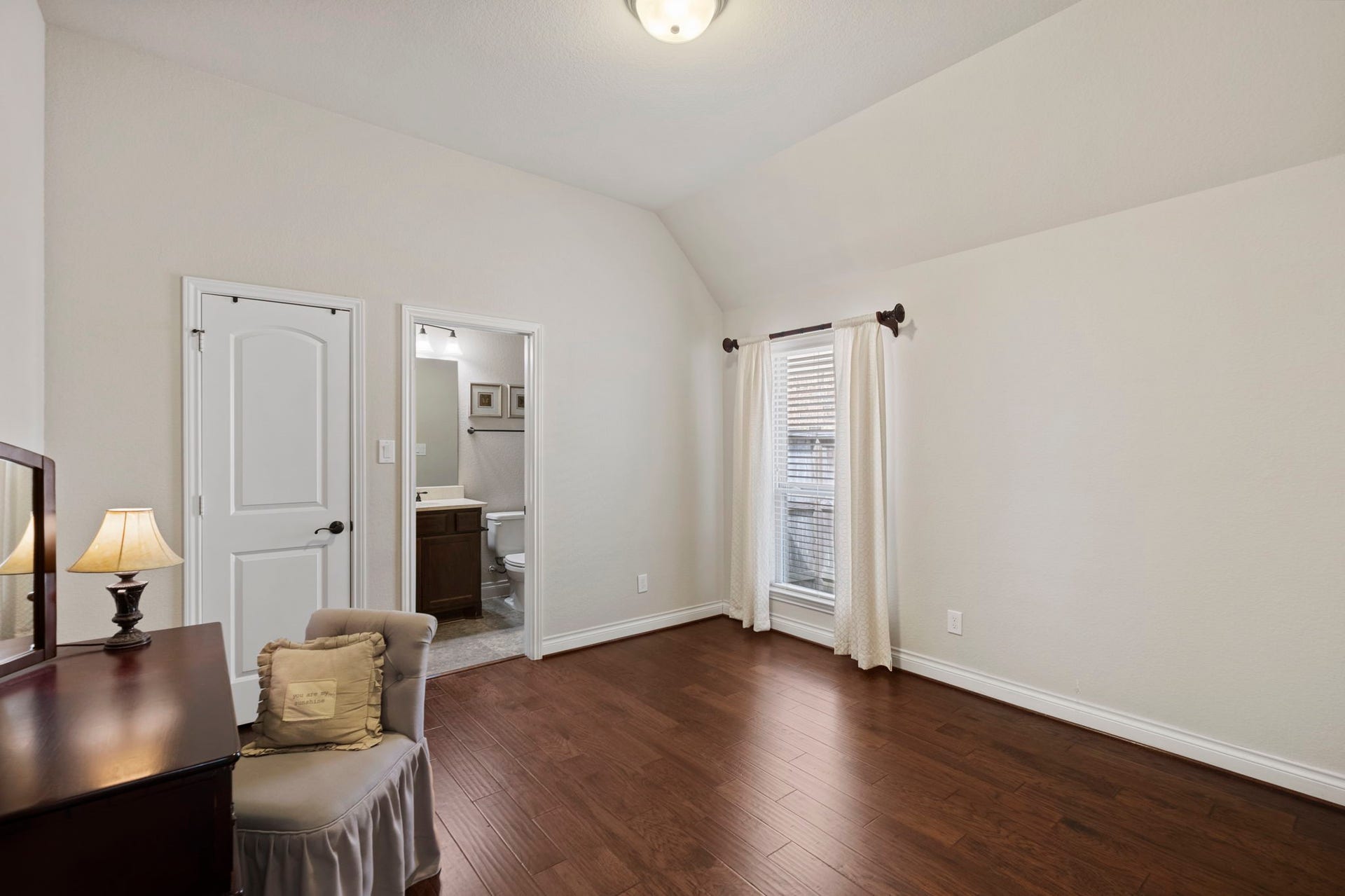 2030 Rainy Mist Drive, Missouri City, TX 77459 Generously sized secondary bedroom offers a peaceful retreat with warm wood flooring and plenty of room for additional furnishings.