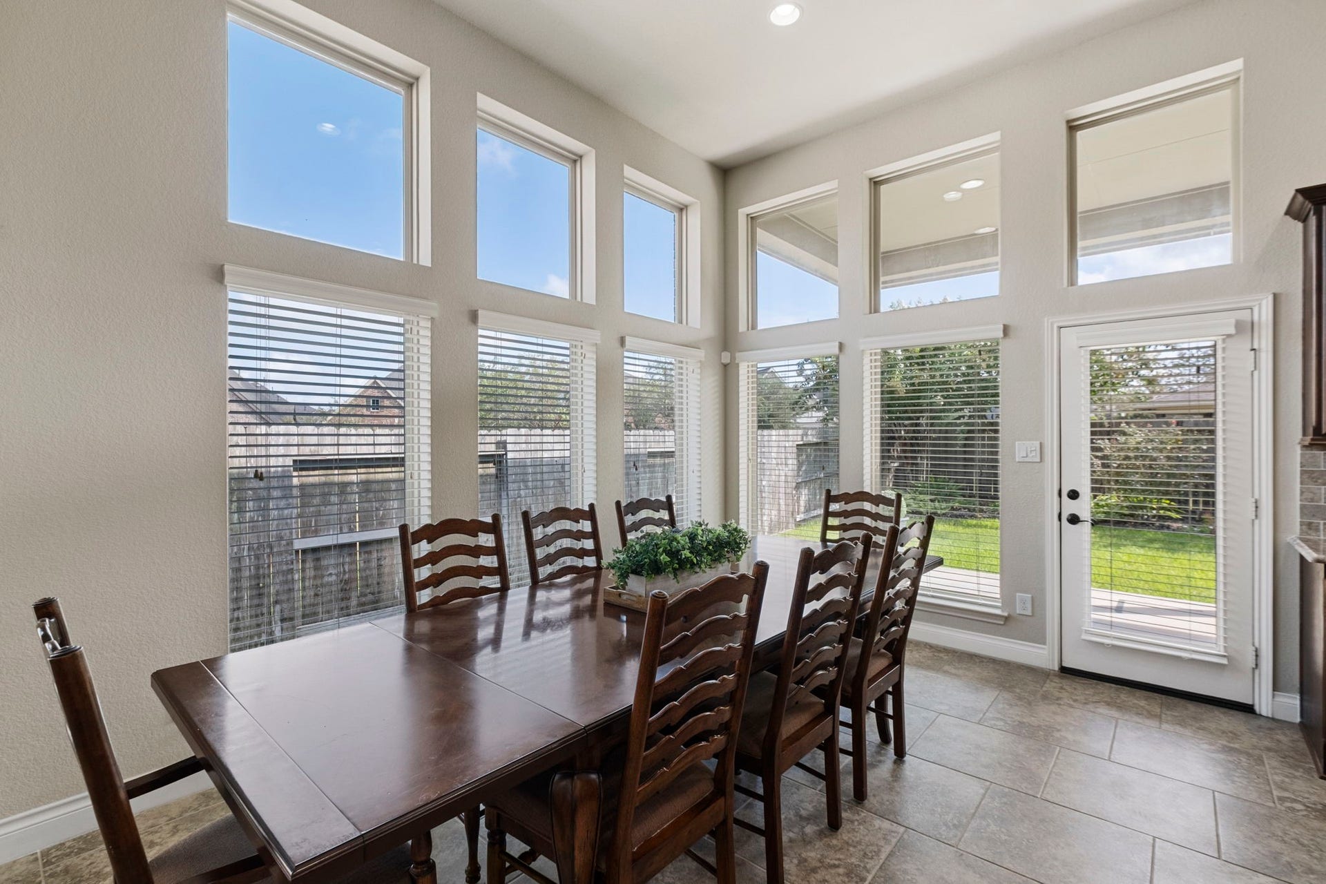 2030 Rainy Mist Drive, Missouri City, TX 77459 Bright breakfast area is wrapped in windows, creating a cheerful setting for casual meals.