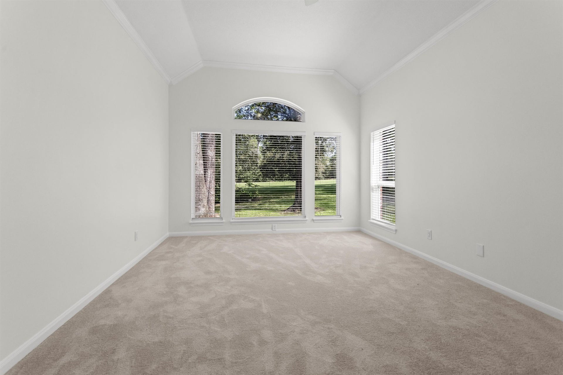 13 Royal Dalton Circle, Conroe, TX 77304 The primary bedroom is oversized, easily accommodating large furniture and a sitting area for enjoying the backyard views. This space has been refreshed with new carpet and fresh paint.