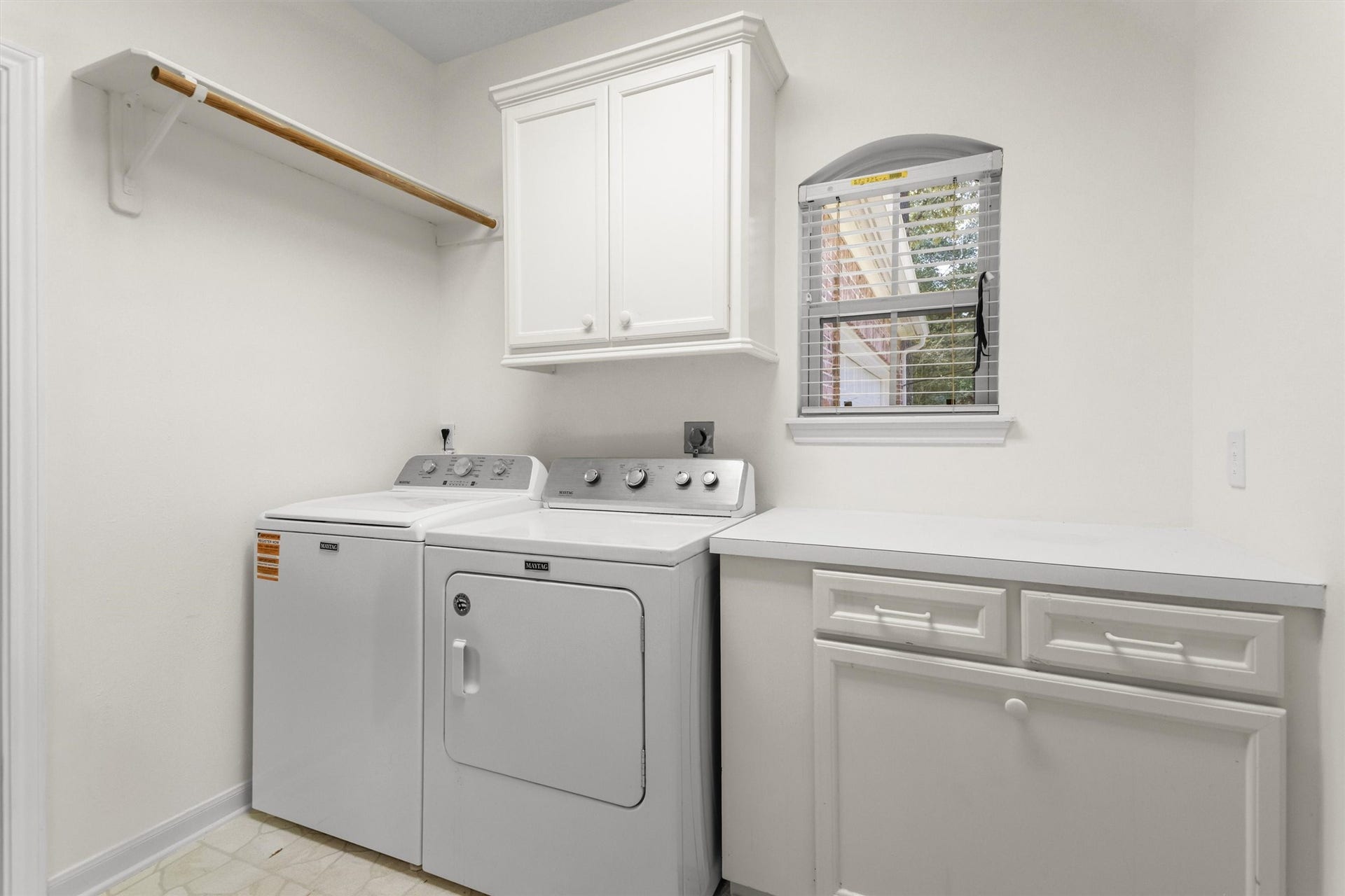 13 Royal Dalton Circle, Conroe, TX 77304 Another view of the laundry room featuring the folding workspace and a window that provides natural light. Washer and dryer are included.