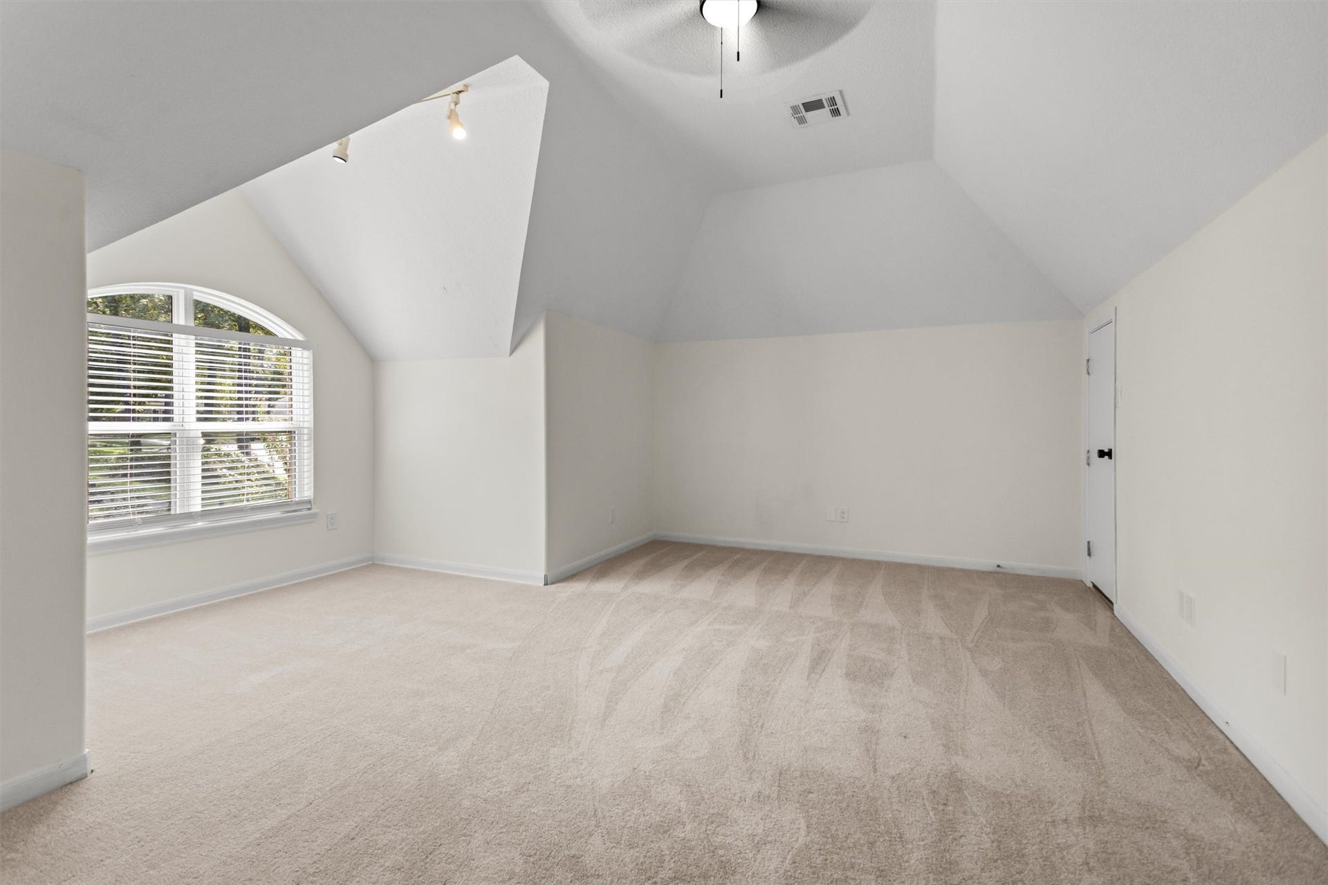 13 Royal Dalton Circle, Conroe, TX 77304 This spacious room located above the garage is perfect for use as a game room, media room, or bunk room. It includes two convenient access points to the attic, providing easy entry to storage areas and the HVAC units.