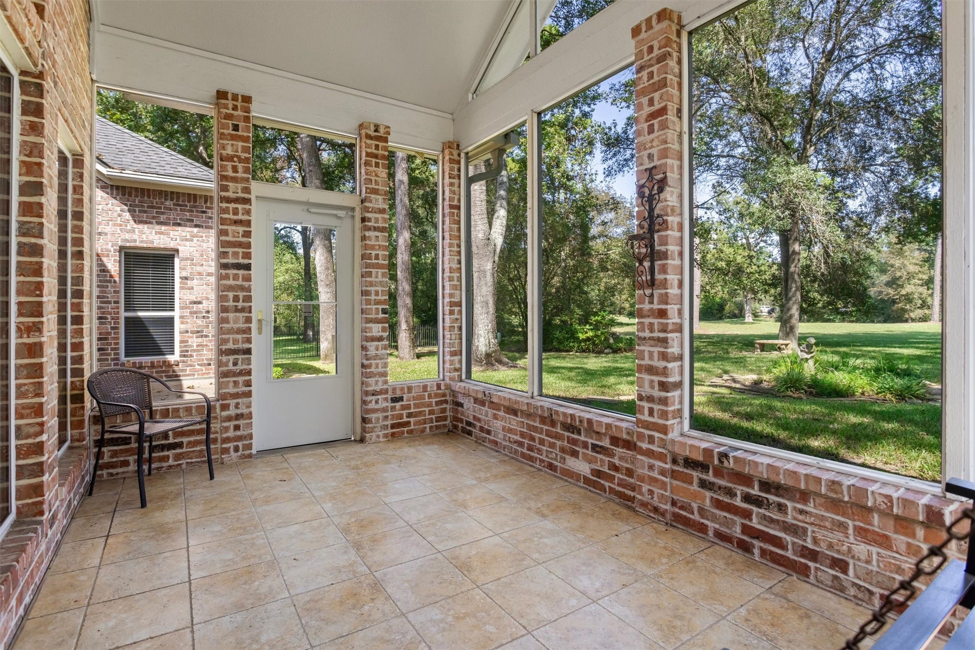 13 Royal Dalton Circle, Conroe, TX 77304 The screened in sunroom allows you to enjoy the outdoors year round in Conroe. With no back neighbors, you can enjoy the peaceful view of the greenspace while sipping your coffee.