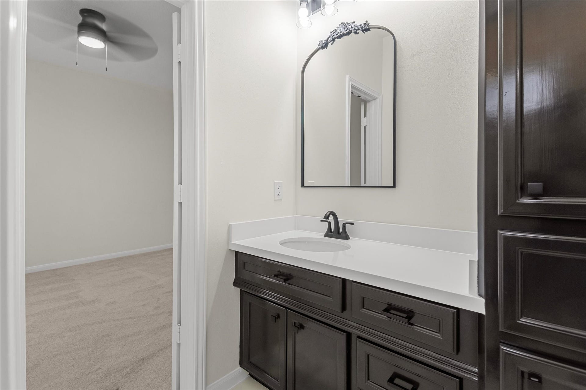 13 Royal Dalton Circle, Conroe, TX 77304 This vanity area in the Hollywood bath highlights the spacious countertop and elegant cabinetry, offering ample storage and prep space.