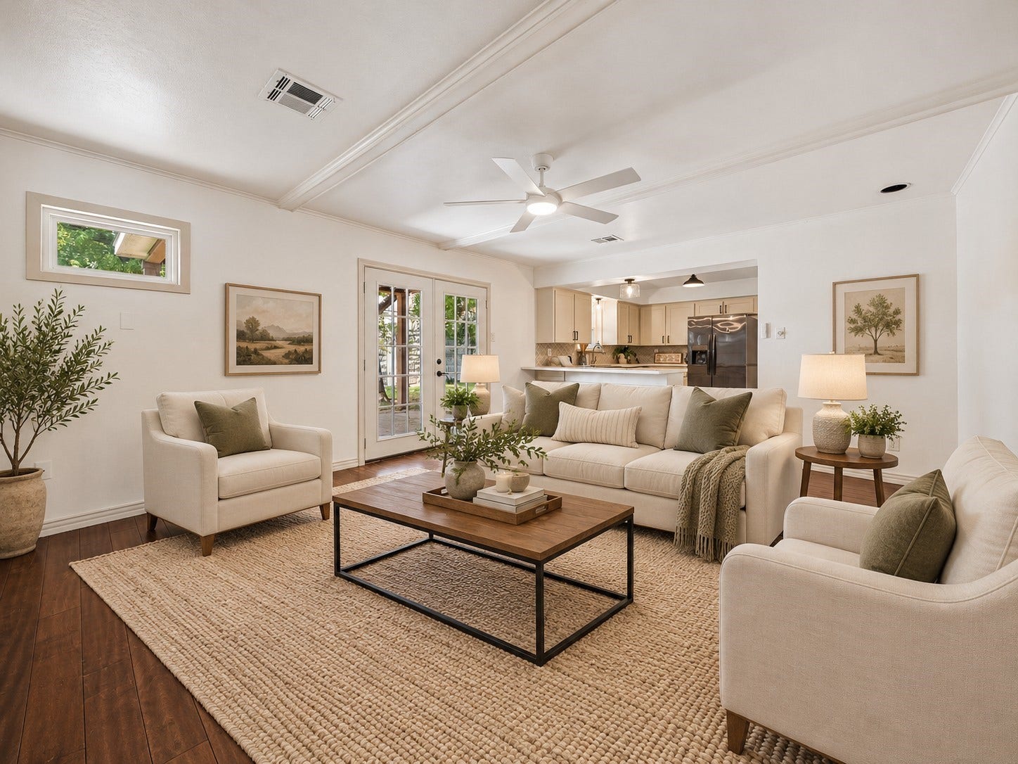 Ditigally Staged. Another view of the family room highlights the open floorplan, connecting the kitchen, living and dining areas.