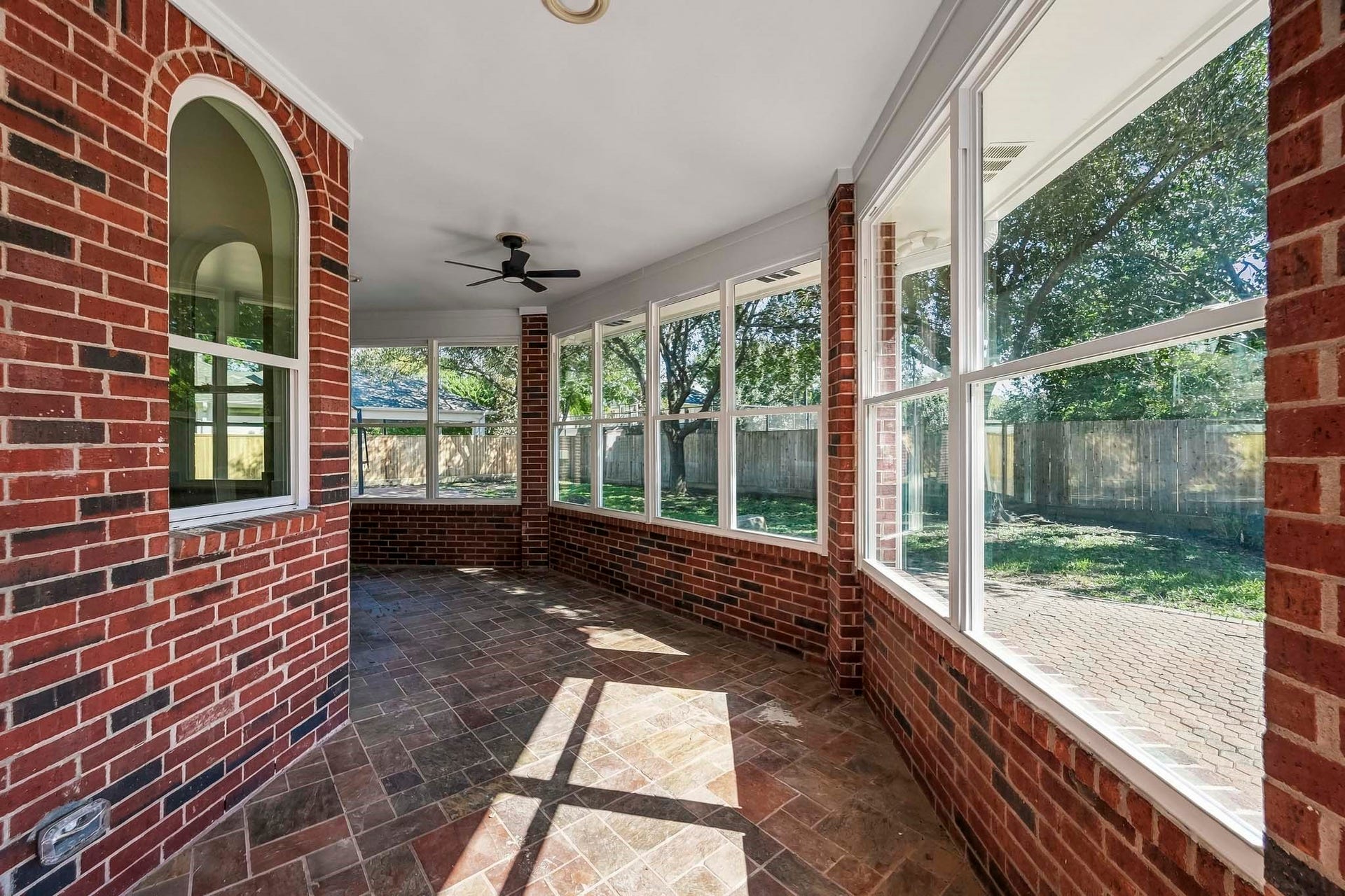 A wraparound covered patio offers outdoor seating and new windows!