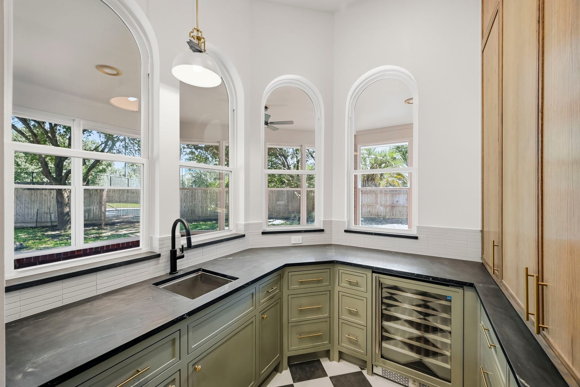 The scullery enjoys a wine cooler and a view of the covered patio!