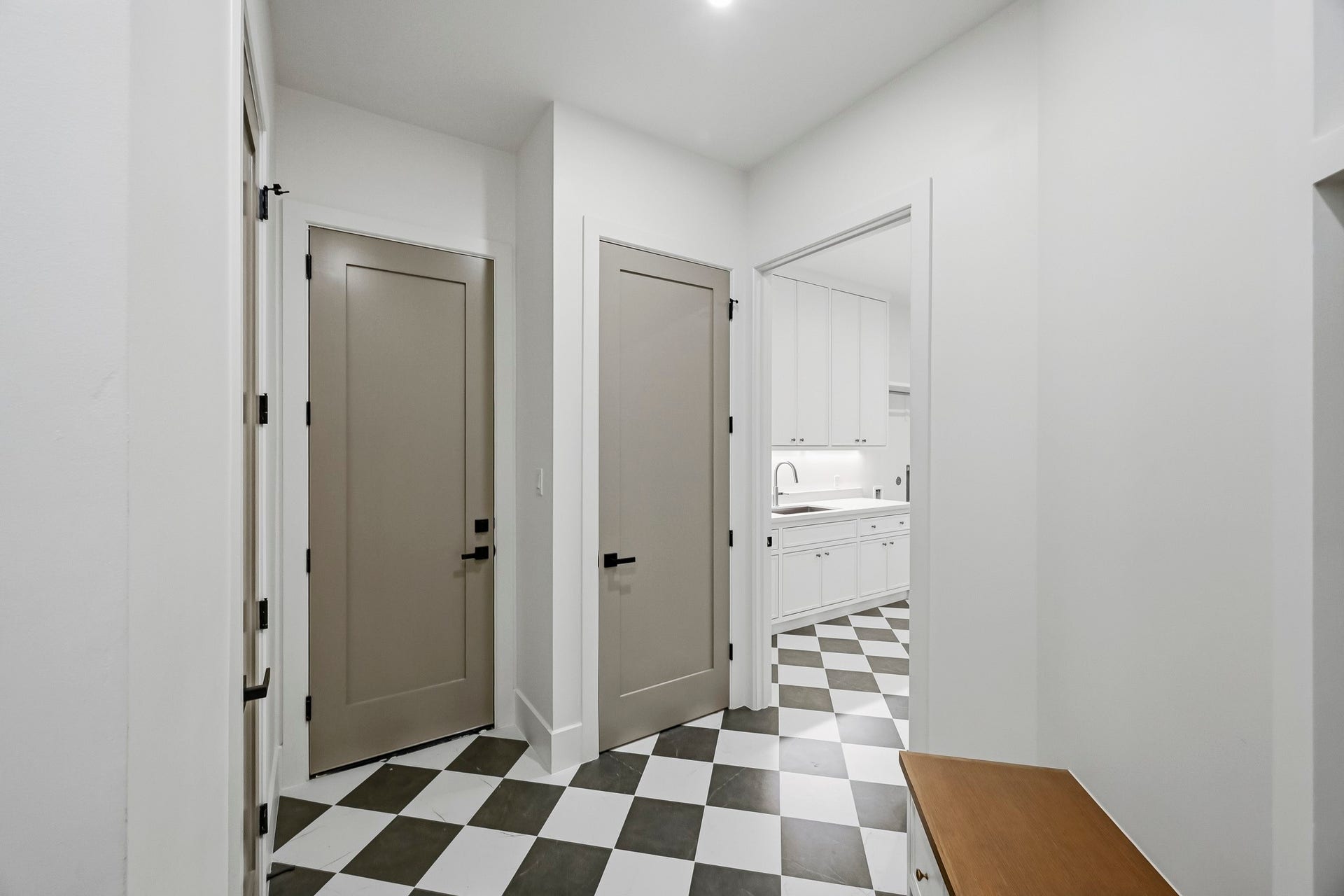 The rear mudroom offers access to a powder bath, utility, and elevator shaft closet!