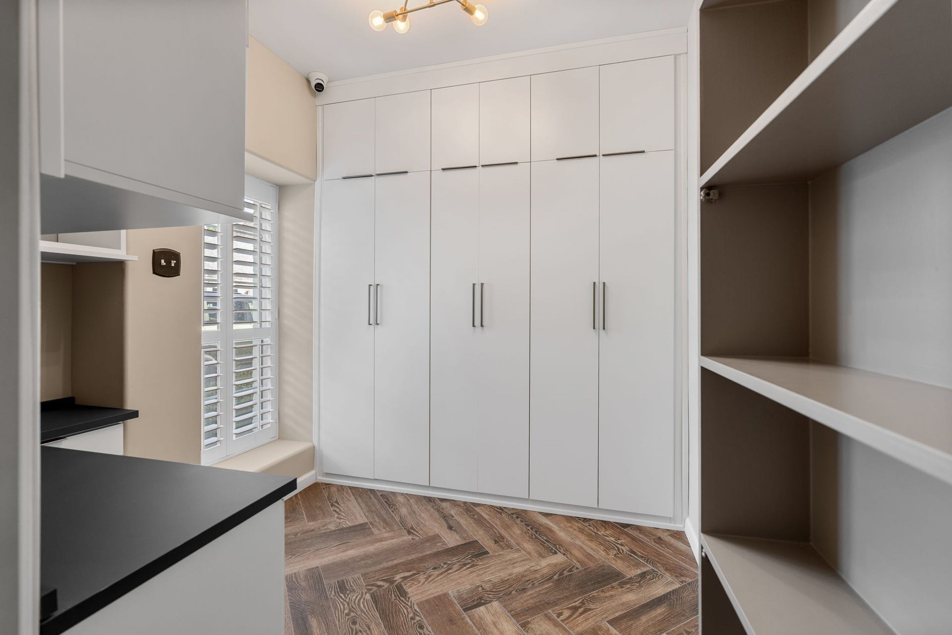 8619 La Fonte Street, Houston, TX 77024 Hidden behind the media rooms bookshelf door, this tucked-away study offers a built-in desk, extensive cabinetry and open shelving for storage and display. A window with plantation shutters brings in natural light, while the herringbone-patterned wood flooring adds warmth and character to this unexpected bonus space.