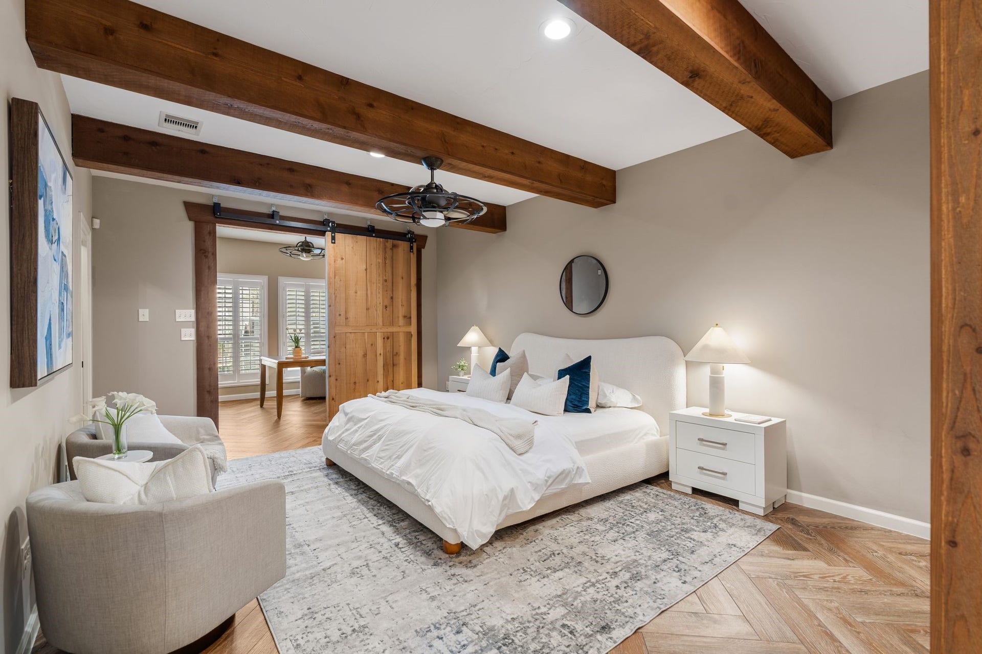 8619 La Fonte Street, Houston, TX 77024 The first-floor primary suite offers a spacious retreat with room for a king-size bed and additional seating. Herringbone-patterned wood-look flooring, exposed wood ceiling beams, recessed lighting and a ceiling fan add warmth and character throughout the room. The suite also includes three closets, providing an exceptional amount of storage.