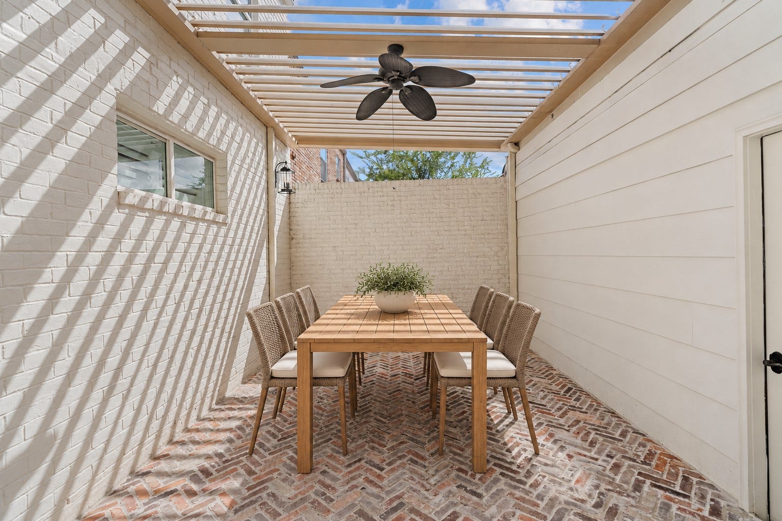 8619 La Fonte Street, Houston, TX 77024 Located just off the formal dining room, this private brick courtyard features herringbone brick flooring and an electric louvered patio cover that can be adjusted for sun or shade. A ceiling fan adds comfort overhead, creating a great setting for outdoor dining, lounging or entertaining. **Note that this photo has been virtually staged.