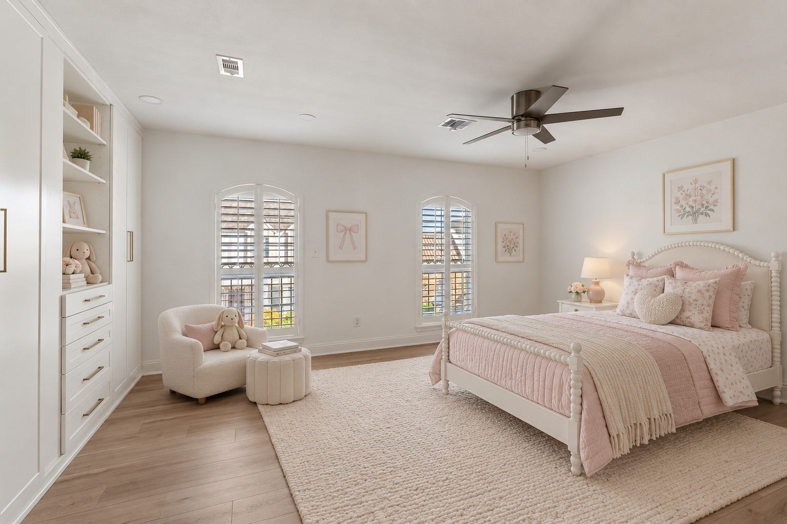 8619 La Fonte Street, Houston, TX 77024 This spacious upstairs secondary bedroom #2 features light wood-look tile flooring, recessed lighting, a modern ceiling fan and two arched windows with plantation shutters. A full wall of custom built-in cabinetry adds exceptional storage, including floor-to-ceiling cabinets, open display shelving and a dedicated built-in desk area with additional shelving above. The bedroom also includes its own ensuite bathroom. **NOTE: this photo has been virtually staged.