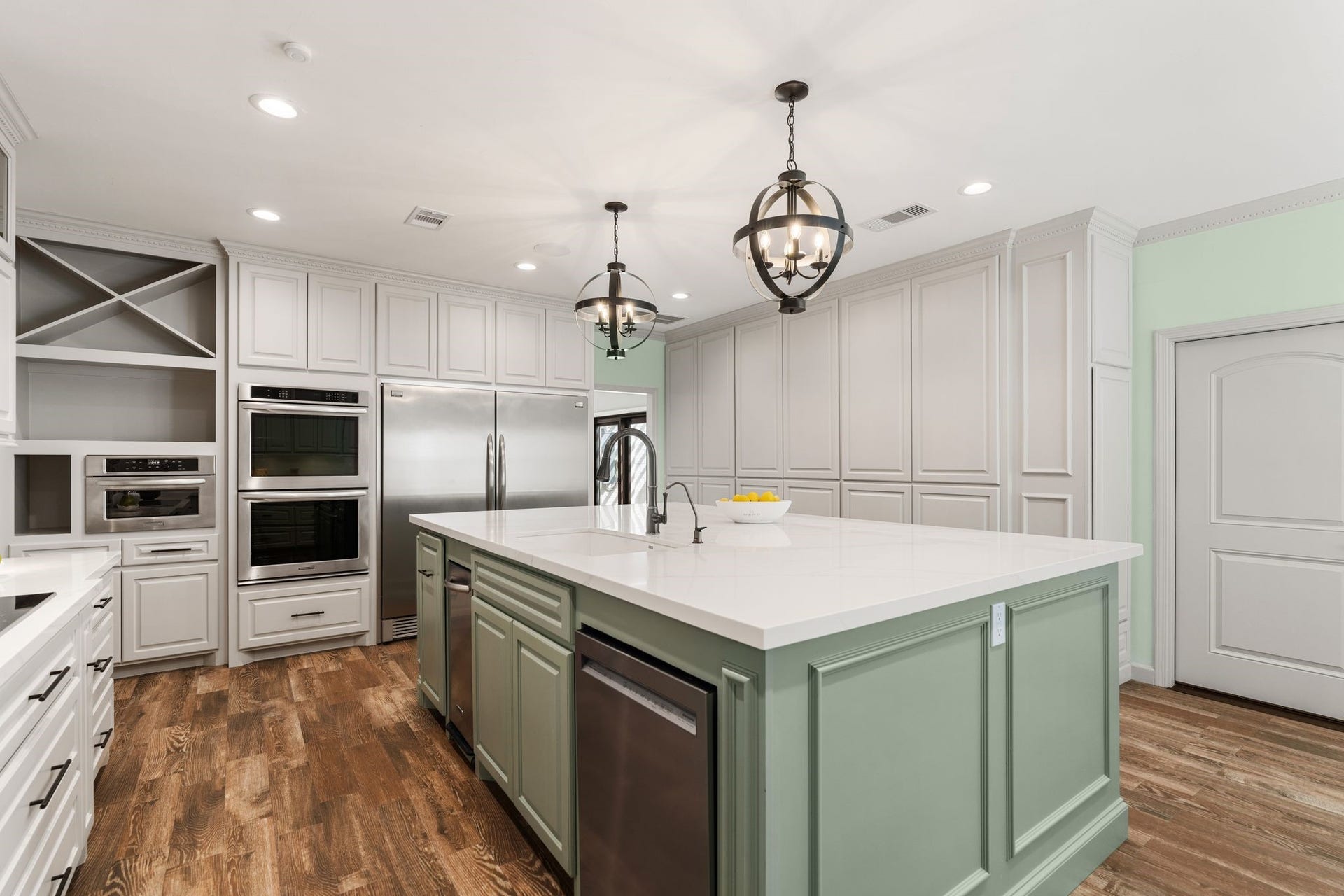 8619 La Fonte Street, Houston, TX 77024 This angle highlights the kitchens extensive cabinetry and stainless steel appliance package, including double KitchenAid ovens, a built-in KitchenAid microwave and a built-in French-door Frigidaire refrigerator and freezer. The island provides additional prep space and houses the KitchenAid dishwasher, along with a trash compactor and pull-out trash storage. Ample drawers and cabinetry throughout the kitchen provide generous everyday storage.