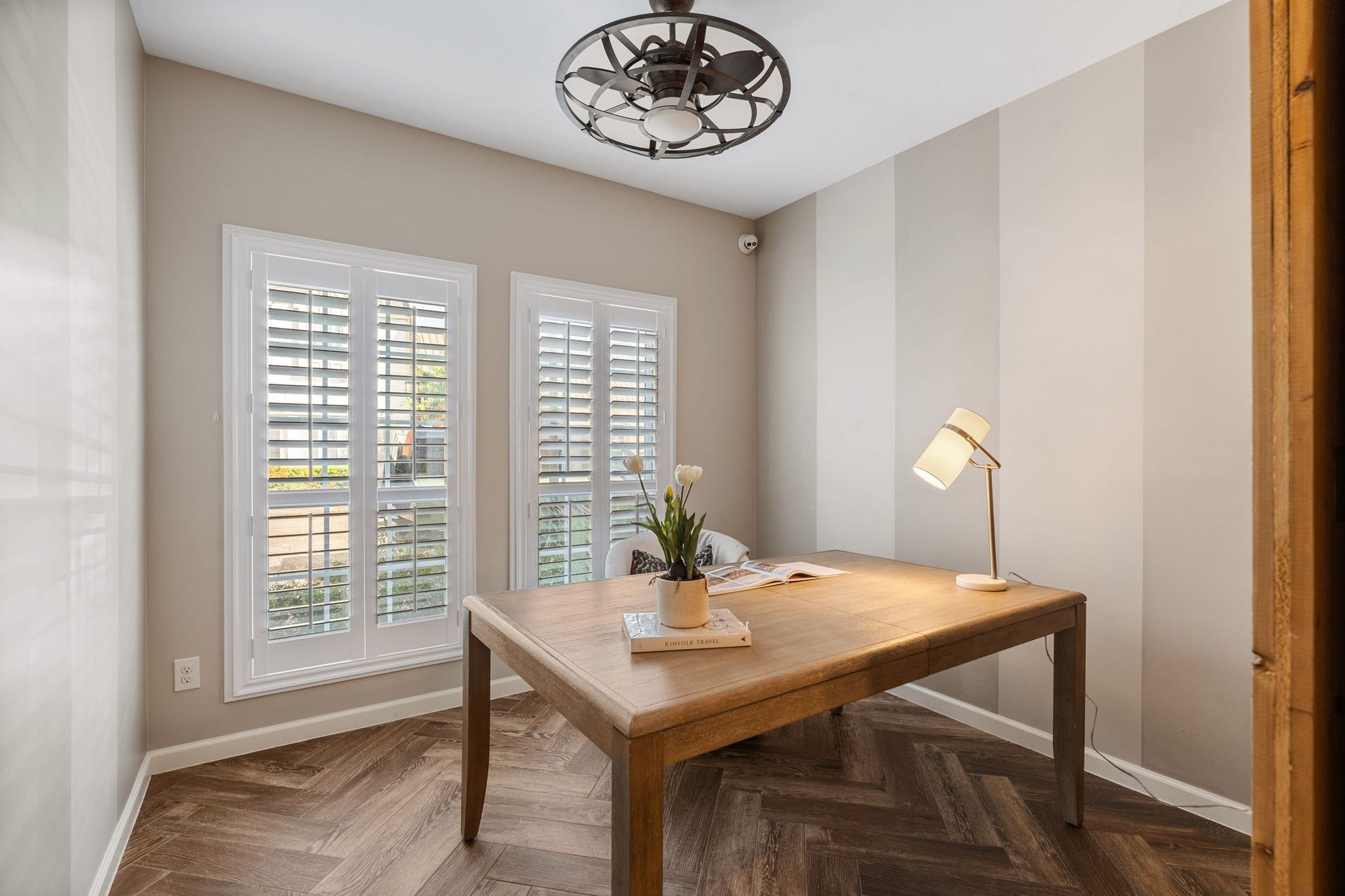 8619 La Fonte Street, Houston, TX 77024 A sliding barn door opens from the primary bedroom to an adjoining flex space that works beautifully as a nursery, private study, reading room or home gym. Herringbone-patterned flooring continues into the space, while two windows with plantation shutters bring in natural light and make this an especially useful extension of the primary suite.