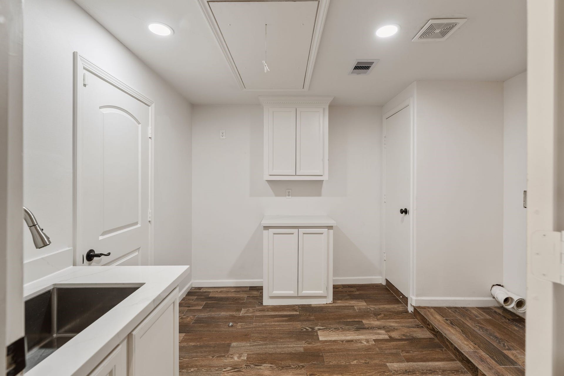 8619 La Fonte Street, Houston, TX 77024 Located just off the kitchen, the utility room offers generous space for laundry and additional household storage, with built-in cabinetry, a utility sink and room for an additional refrigerator or freezer. The layout is spacious enough to accommodate two washer and dryer sets, making it especially functional for a busy household. A door allows the space to be closed off from the kitchen when needed.