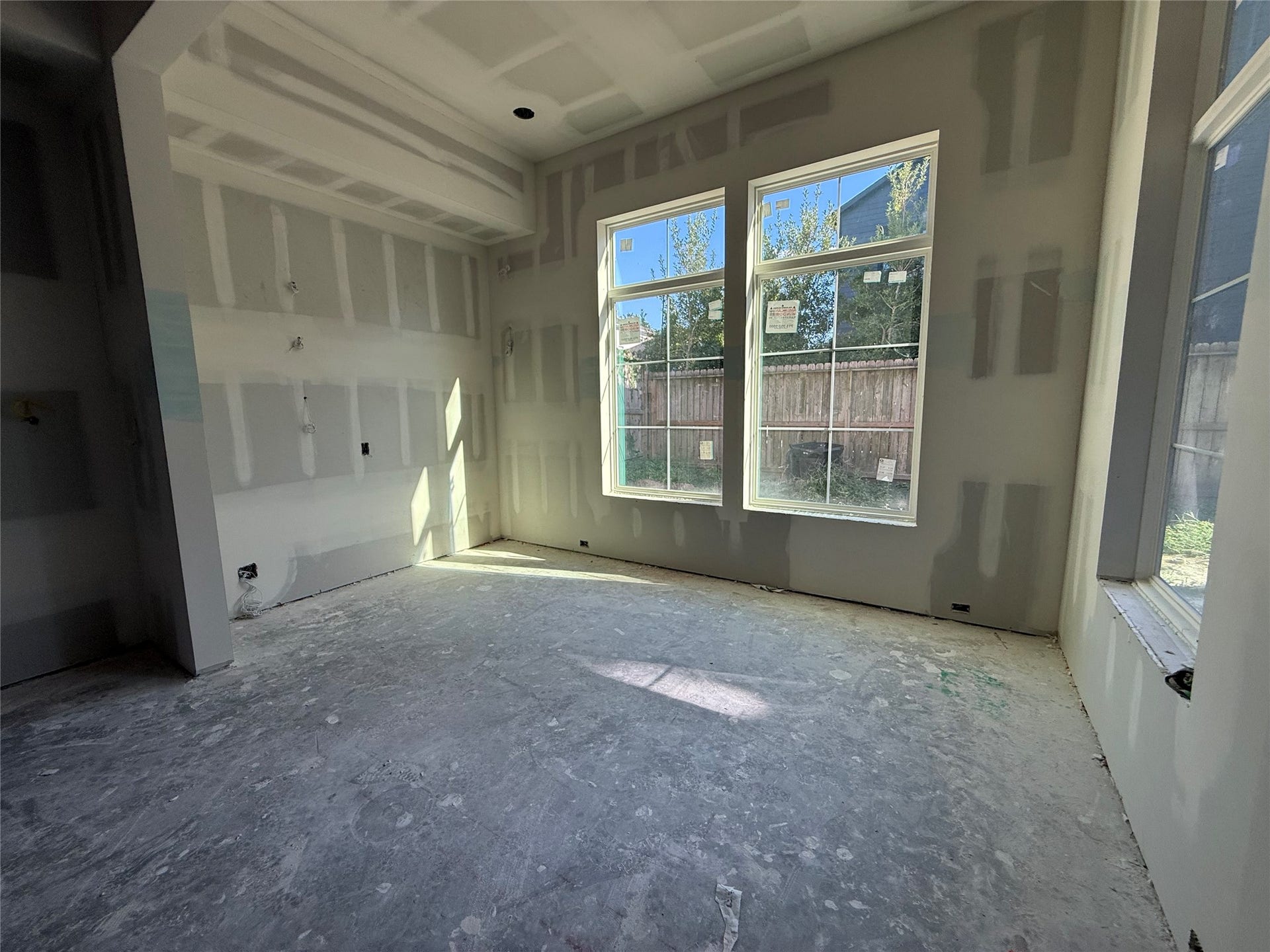 1021 Nadine Street, Houston, TX 77009 Formal dining area with lots of natural light. Shelving and custom cabinetry with reeded glass upper cabinet doors to be built.