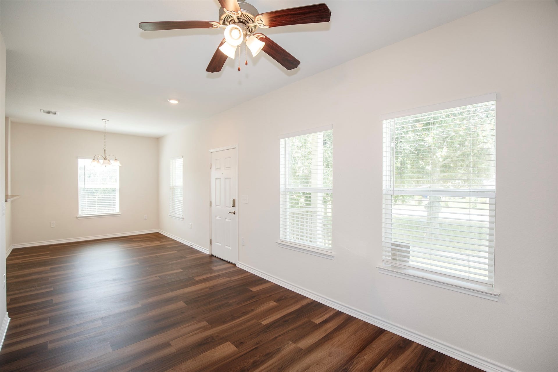 The family room has large windows that overlook the front yard.